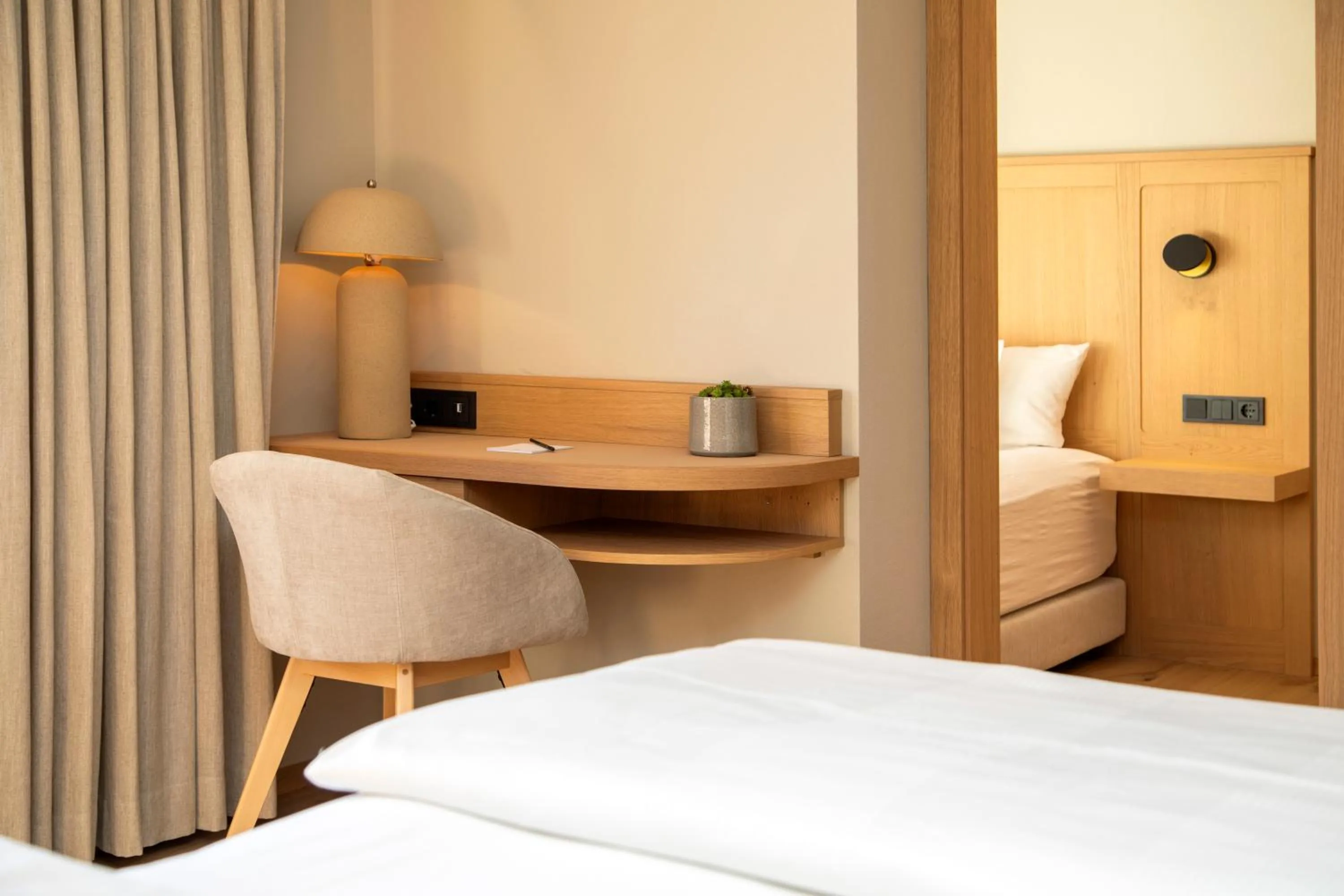 Seating area, Bed in Berghotel Schlossanger Alp