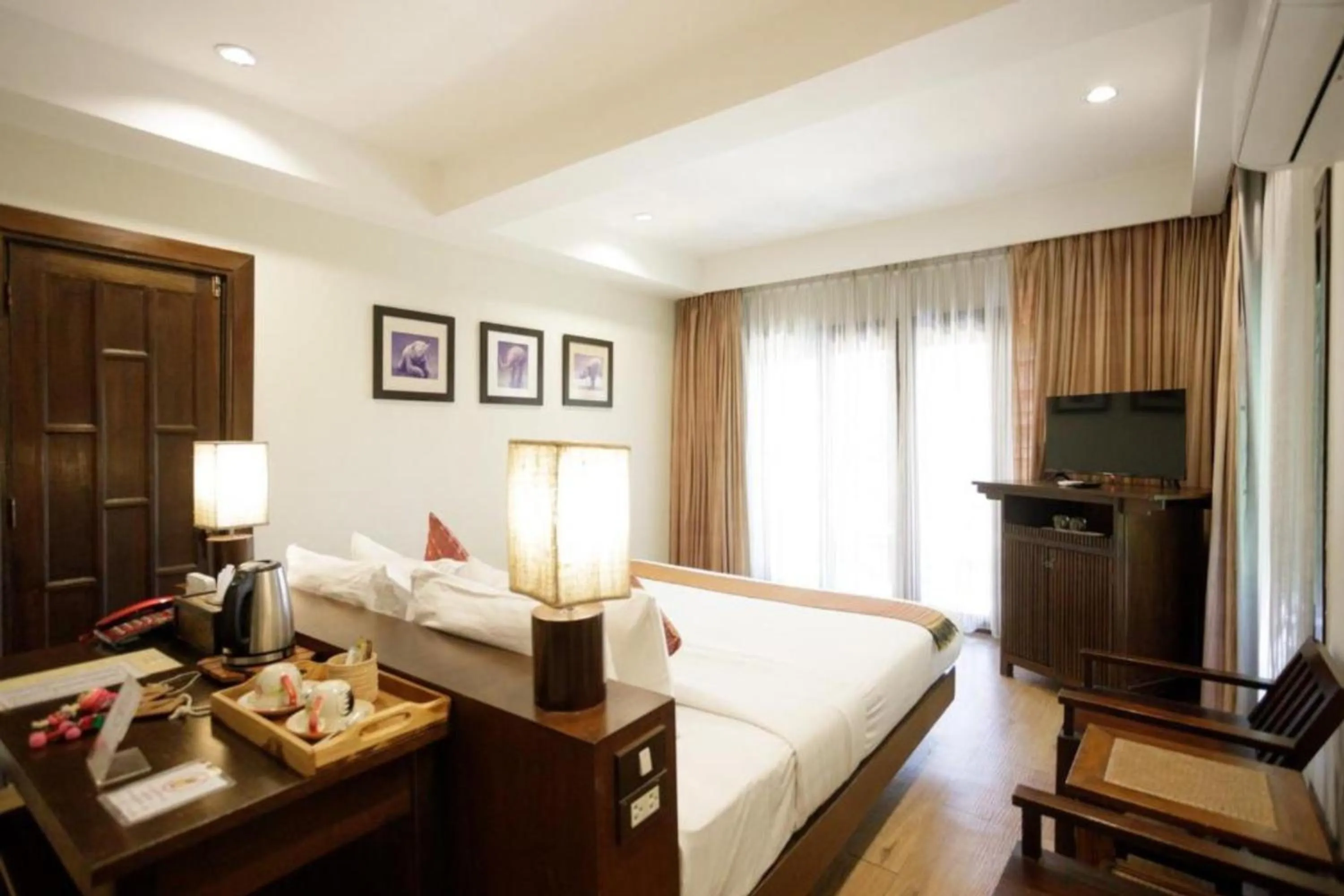 Bed in Lanna Dusita Riverside Boutique Resort