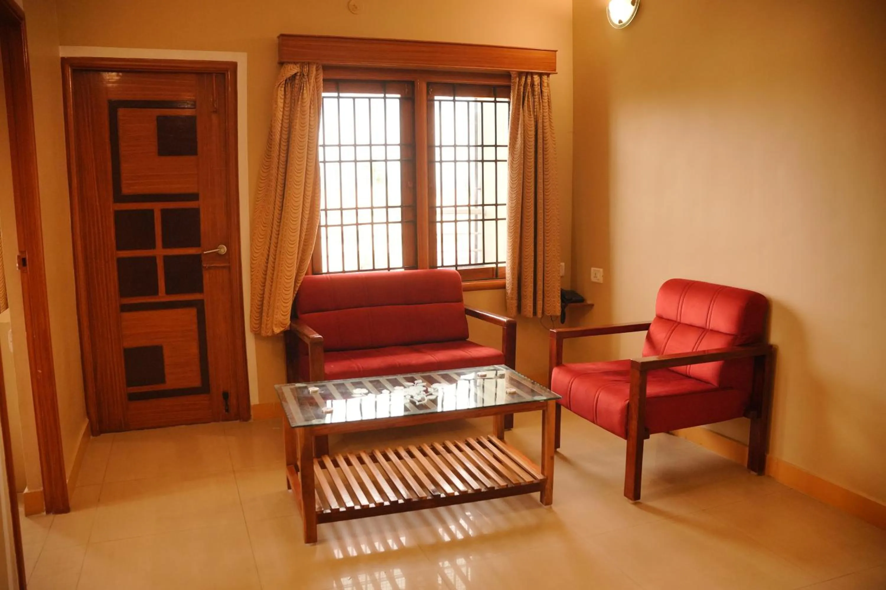 Seating area in HOTEL THIRD EYE by RAMANA TOWERS