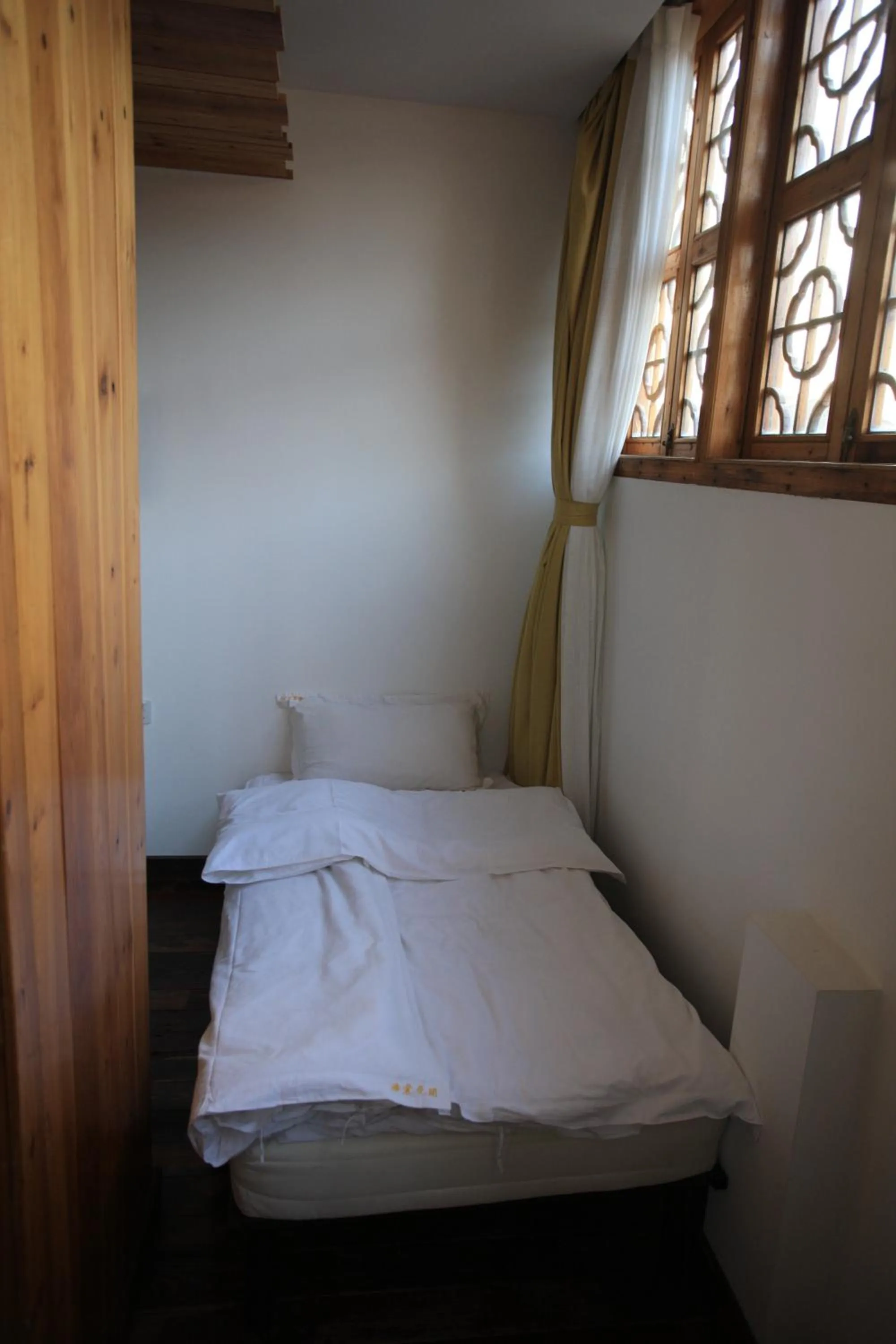 Bed in Tongli Begonia Flowers Guesthouse