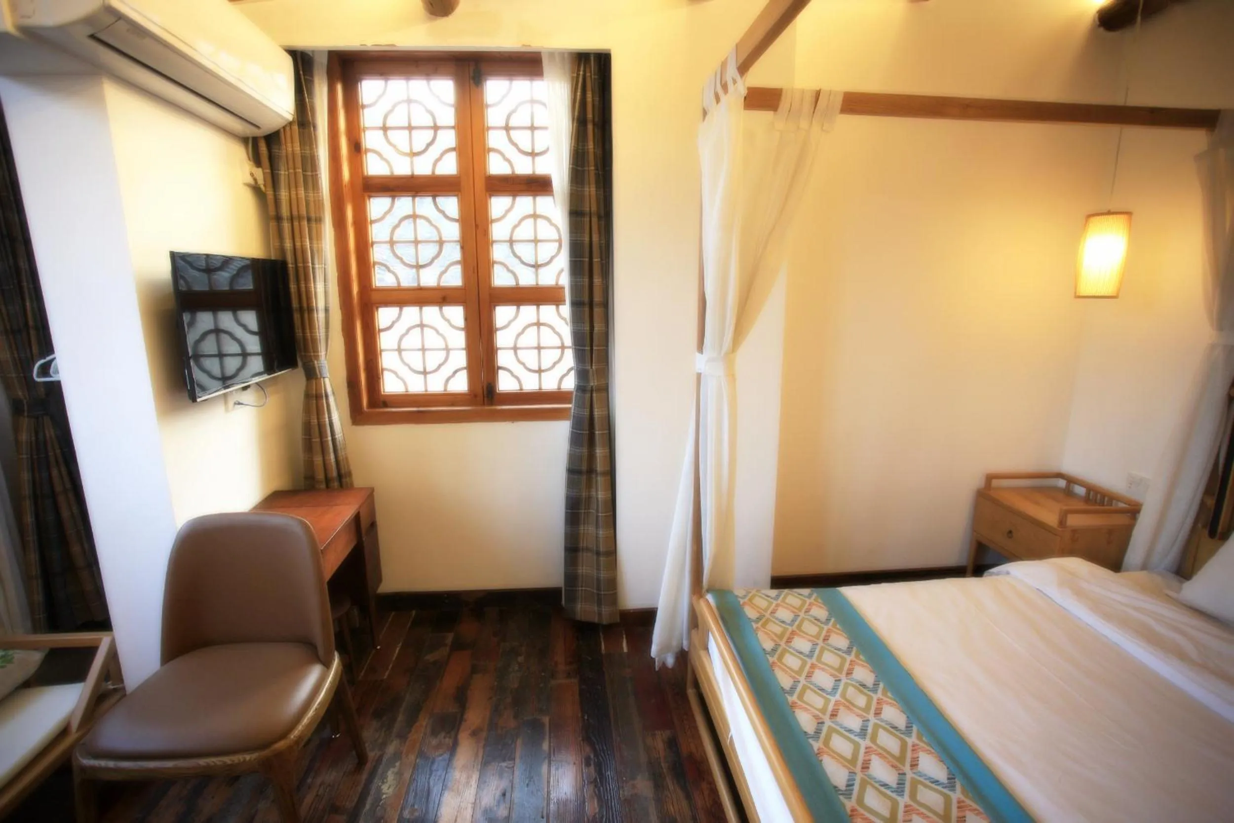 Bed in Tongli Begonia Flowers Guesthouse