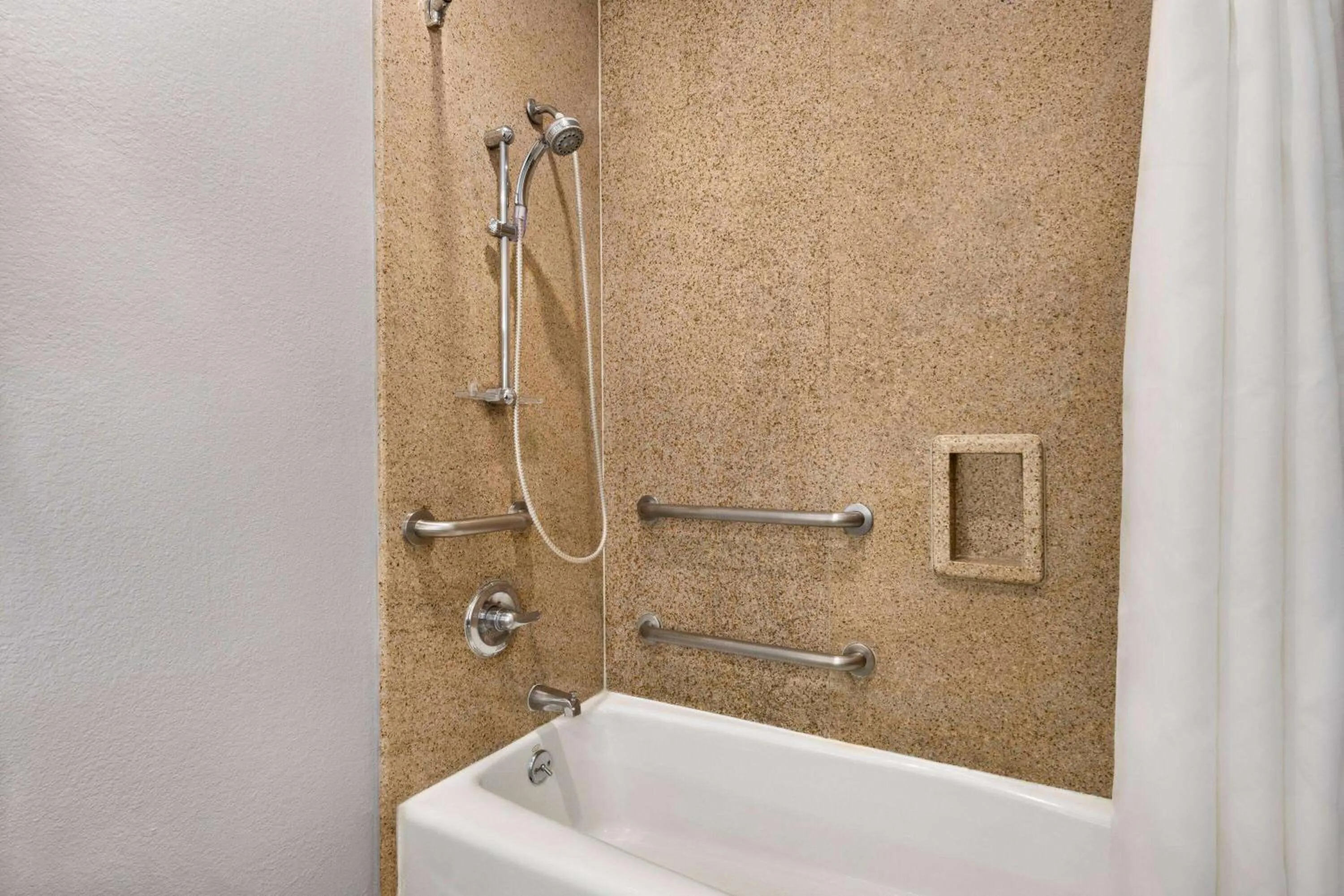 Bathroom in Days Inn & Suites by Wyndham Houston Hobby Airport