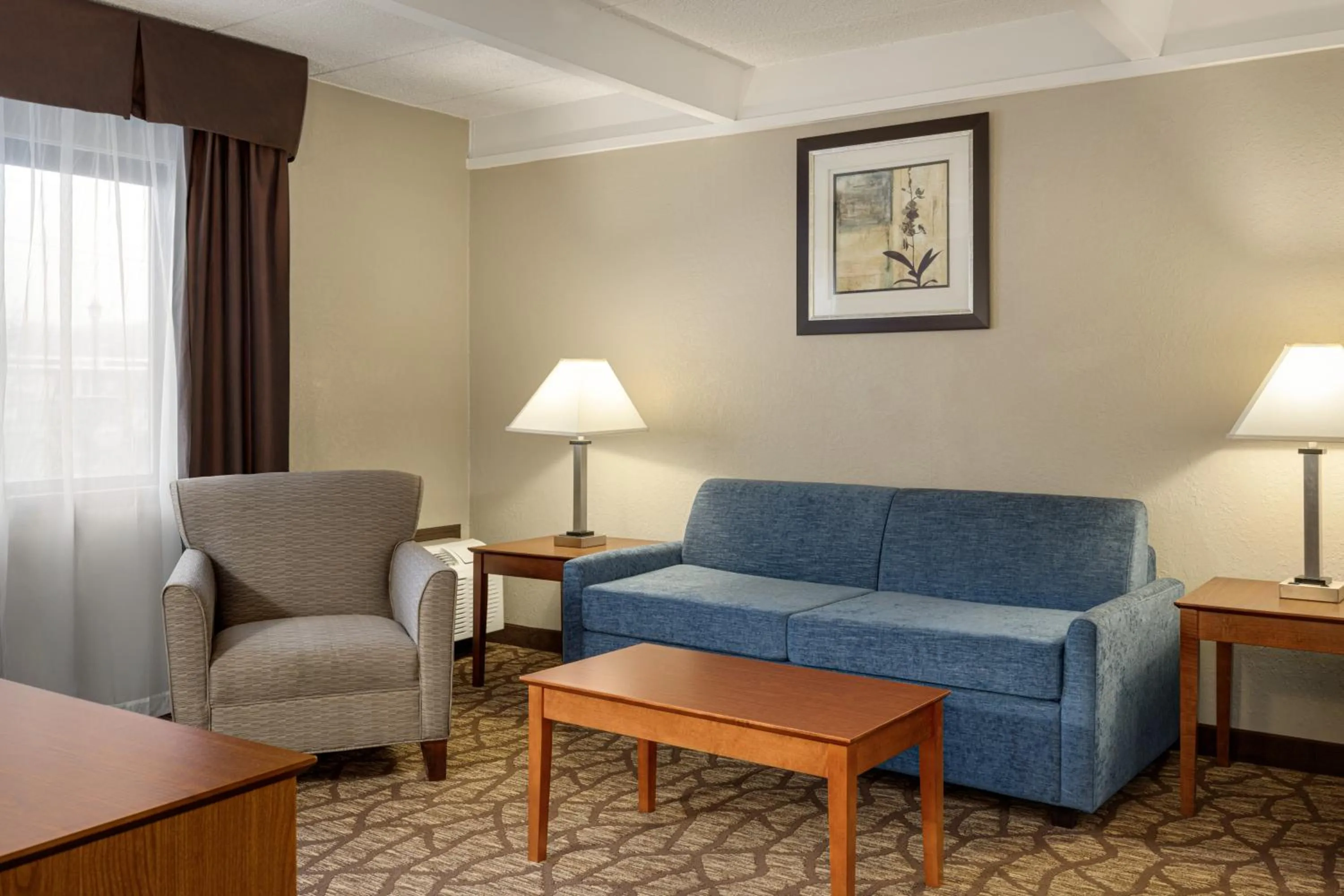 Living room in AmericInn by Wyndham Grand Rapids Airport North