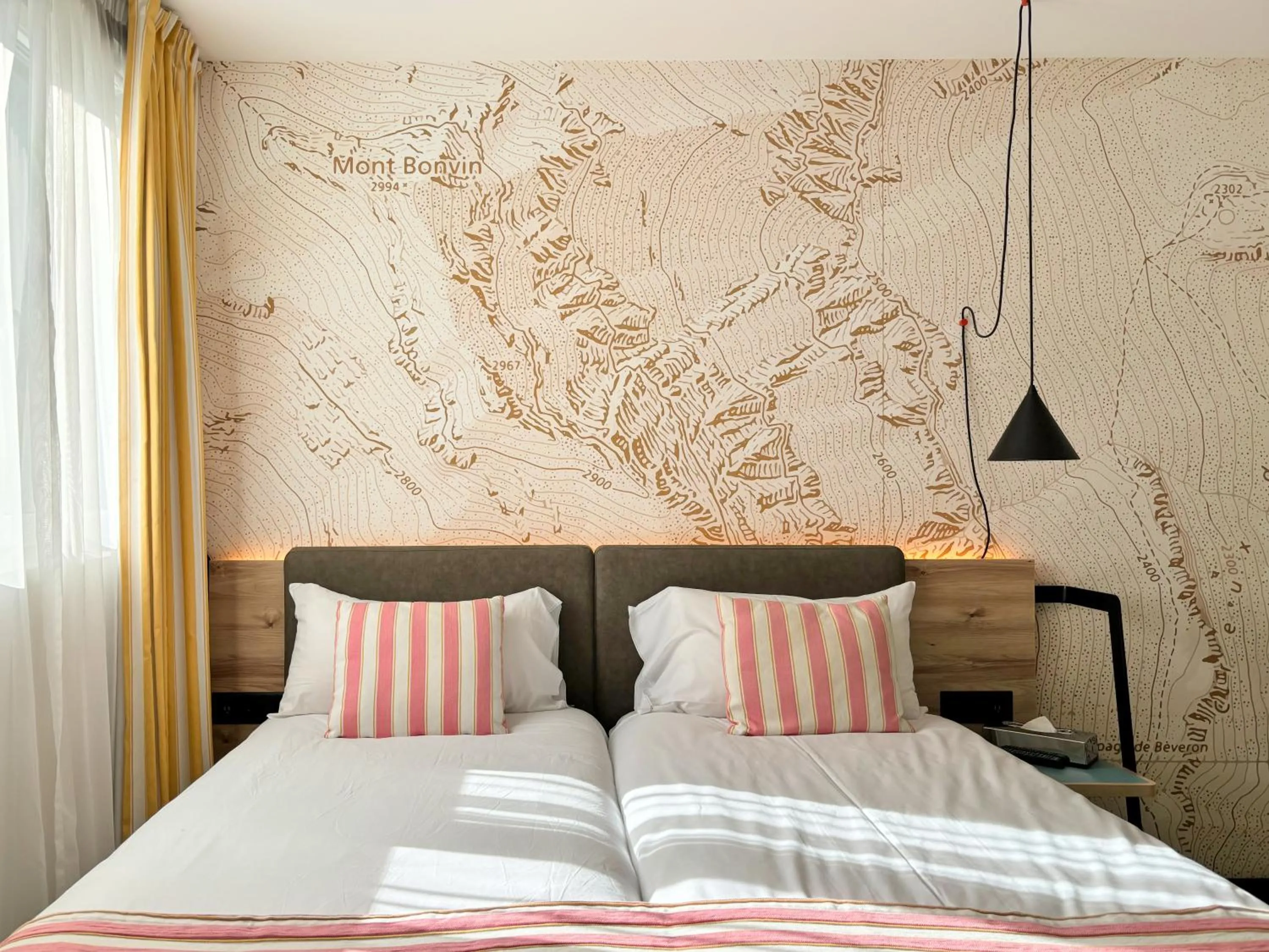 Bed in Nonanteneuf appart hōtel Sierre - contactless check-in