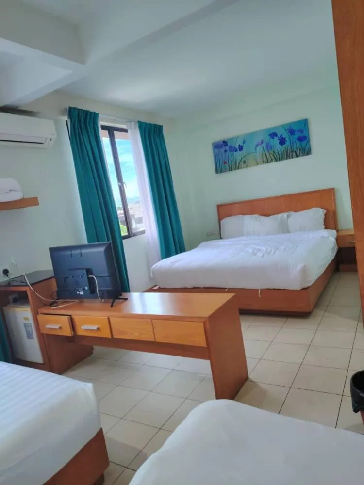 Communal lounge/ TV room, Bed in Fratini's Hotel Labuan