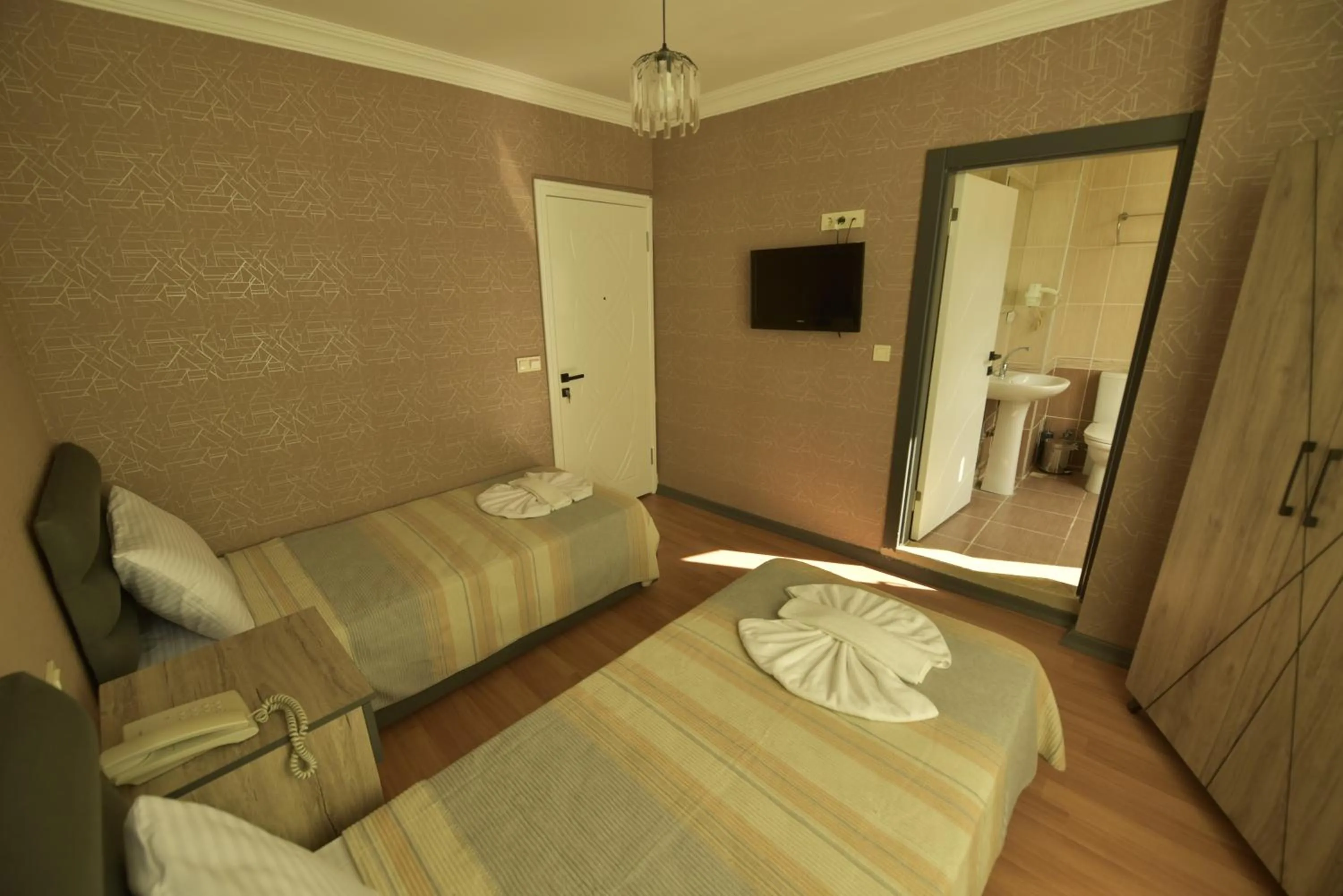 Bed in Omega Luxx Hotel