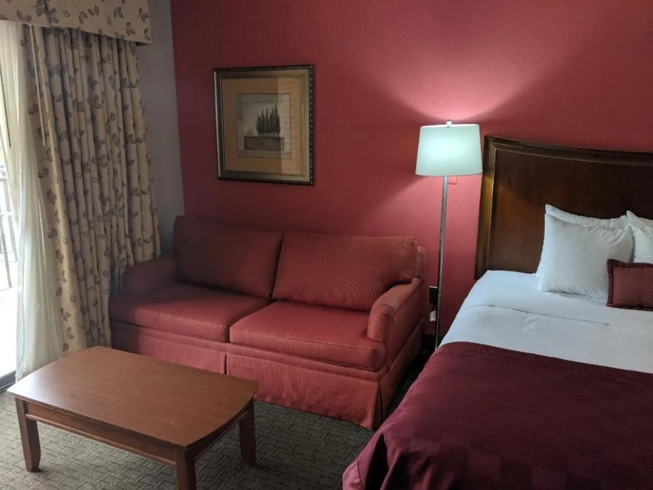 Seating area, Bed in Ramada by Wyndham Raleigh