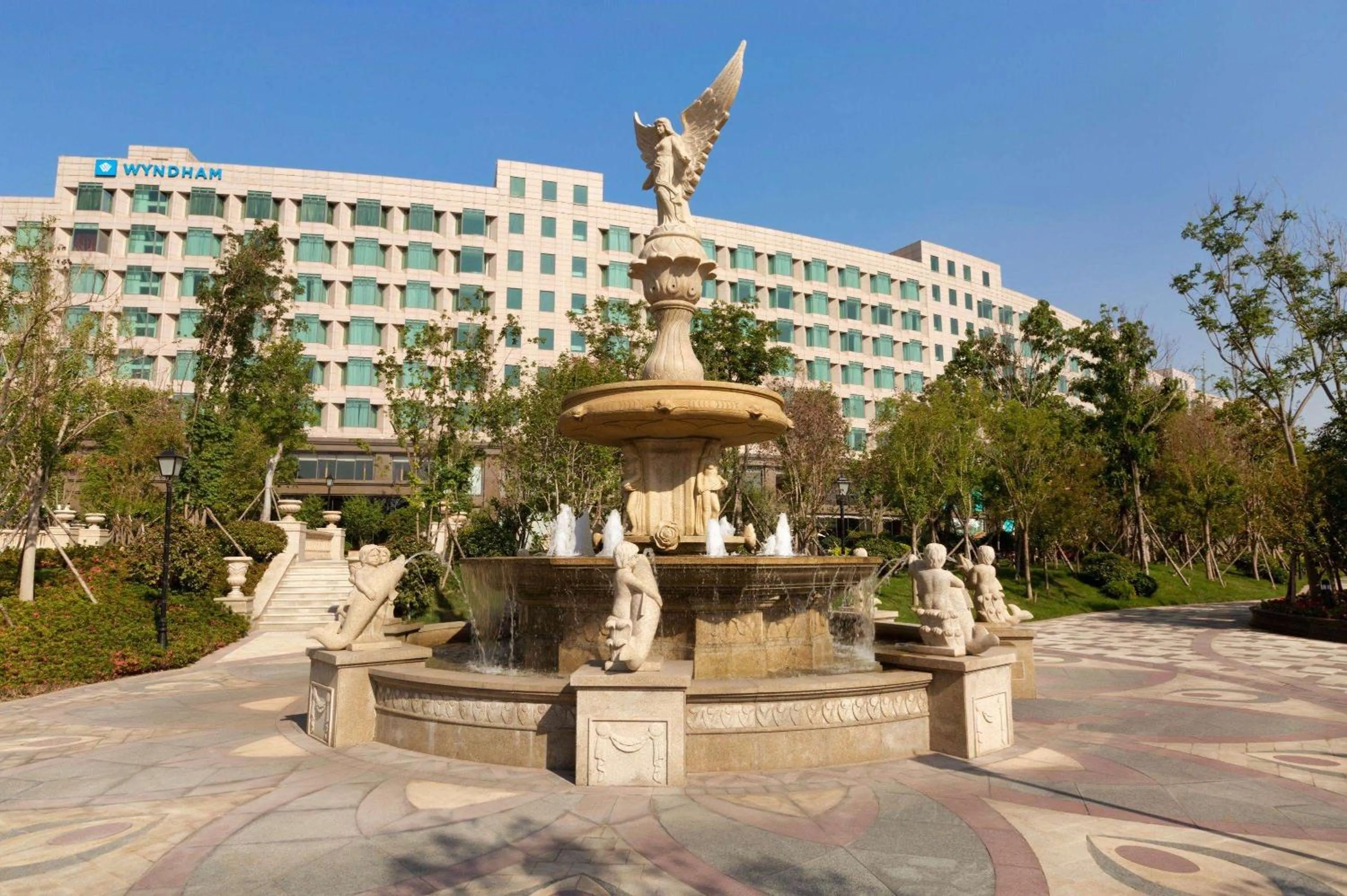 Property building in Wyndham Qingdao l Free Fixed-Time Shuttle Service Between Hotel and Airport & North Railway Station l Outdoor Children's Amusement Park l 1-Hour Play Snooker or Table Tennis
