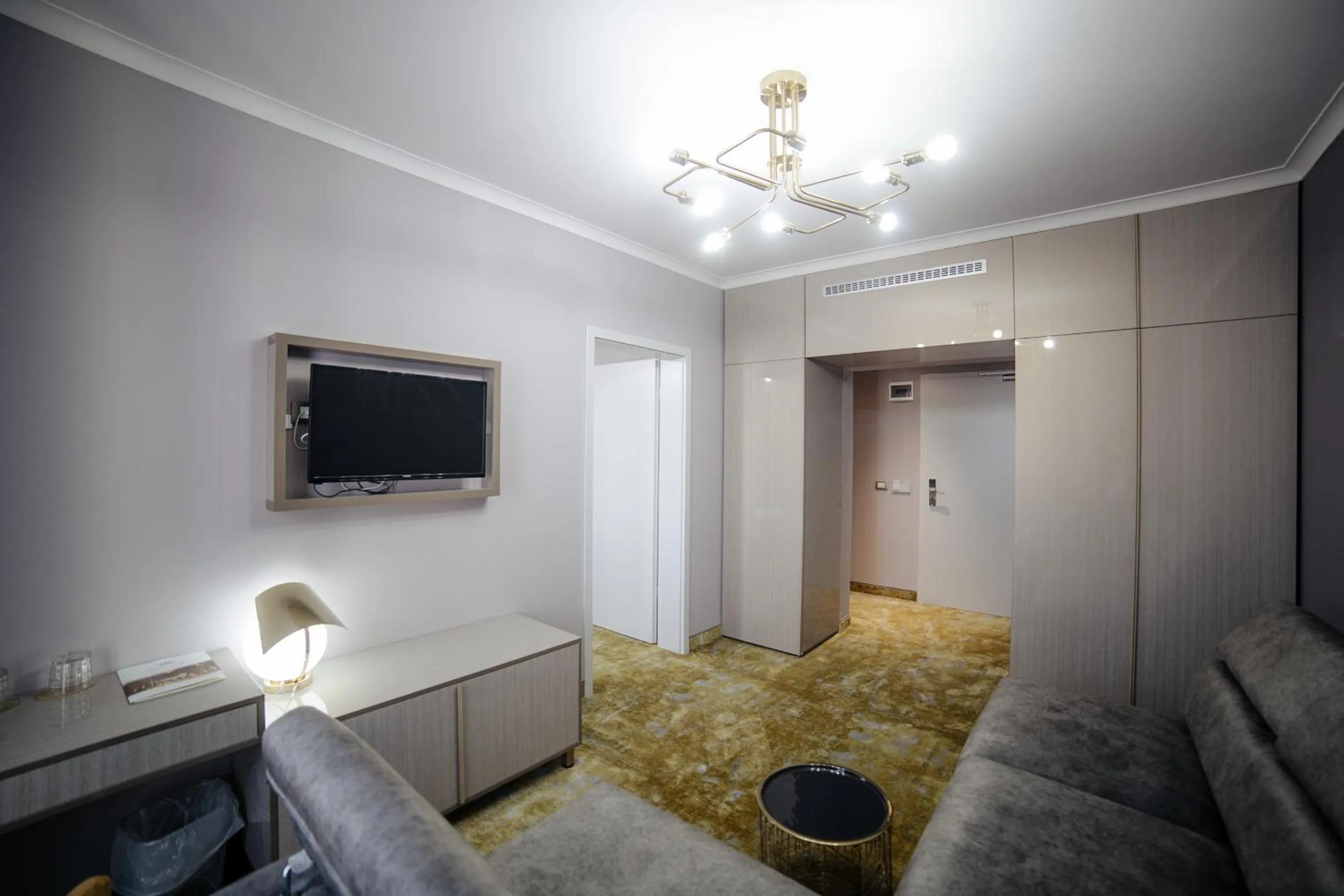 Communal lounge/ TV room, Bed in Royal Class Hotel