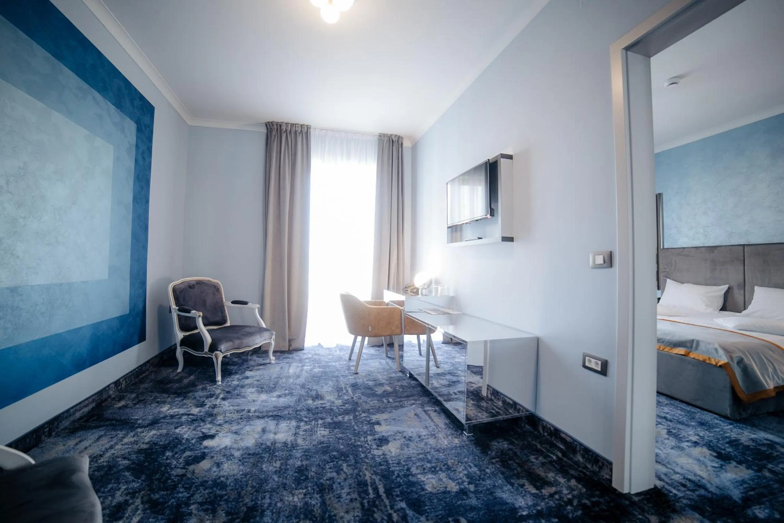 Communal lounge/ TV room, Bed in Royal Class Hotel