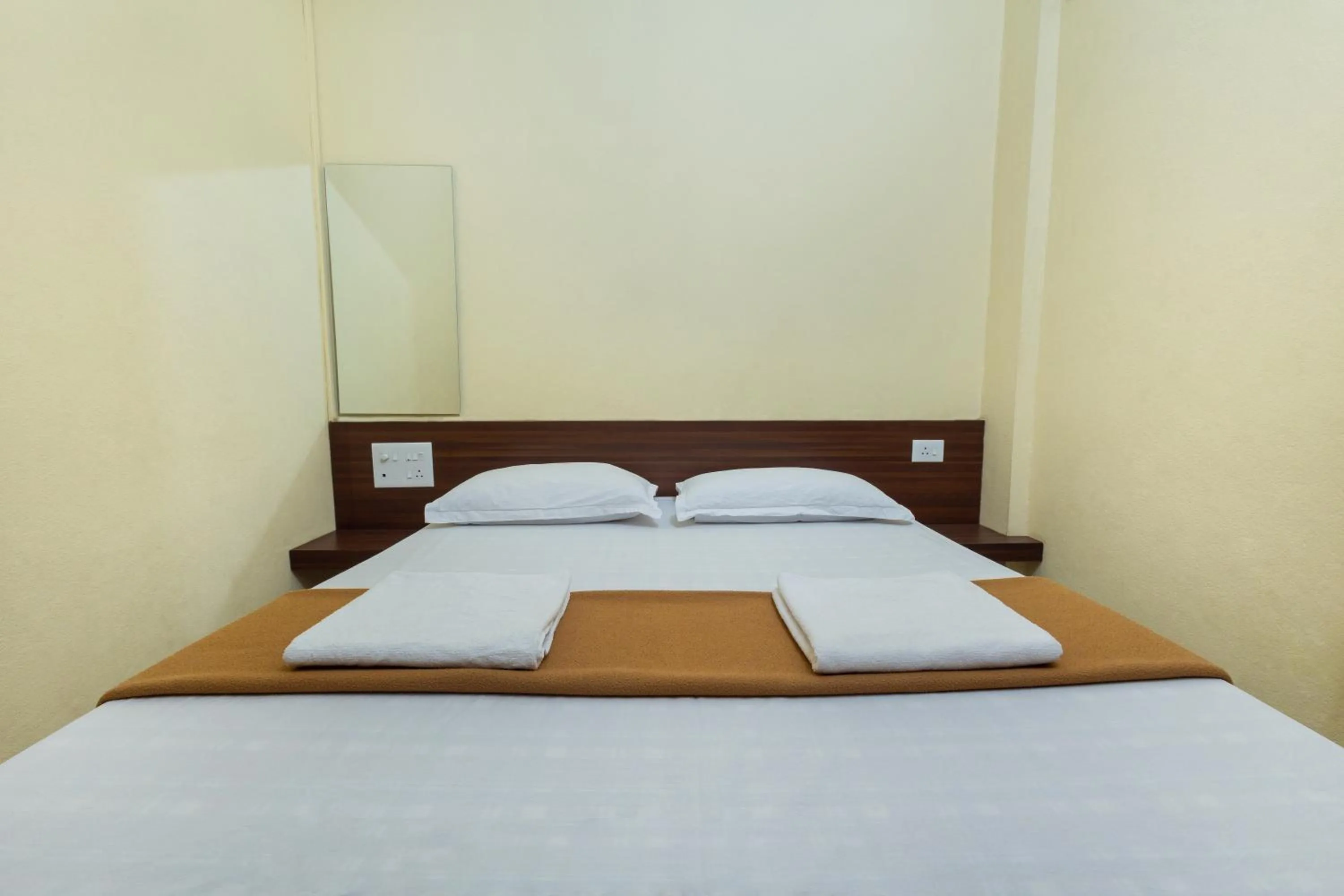 Bed in Hotel Ambika