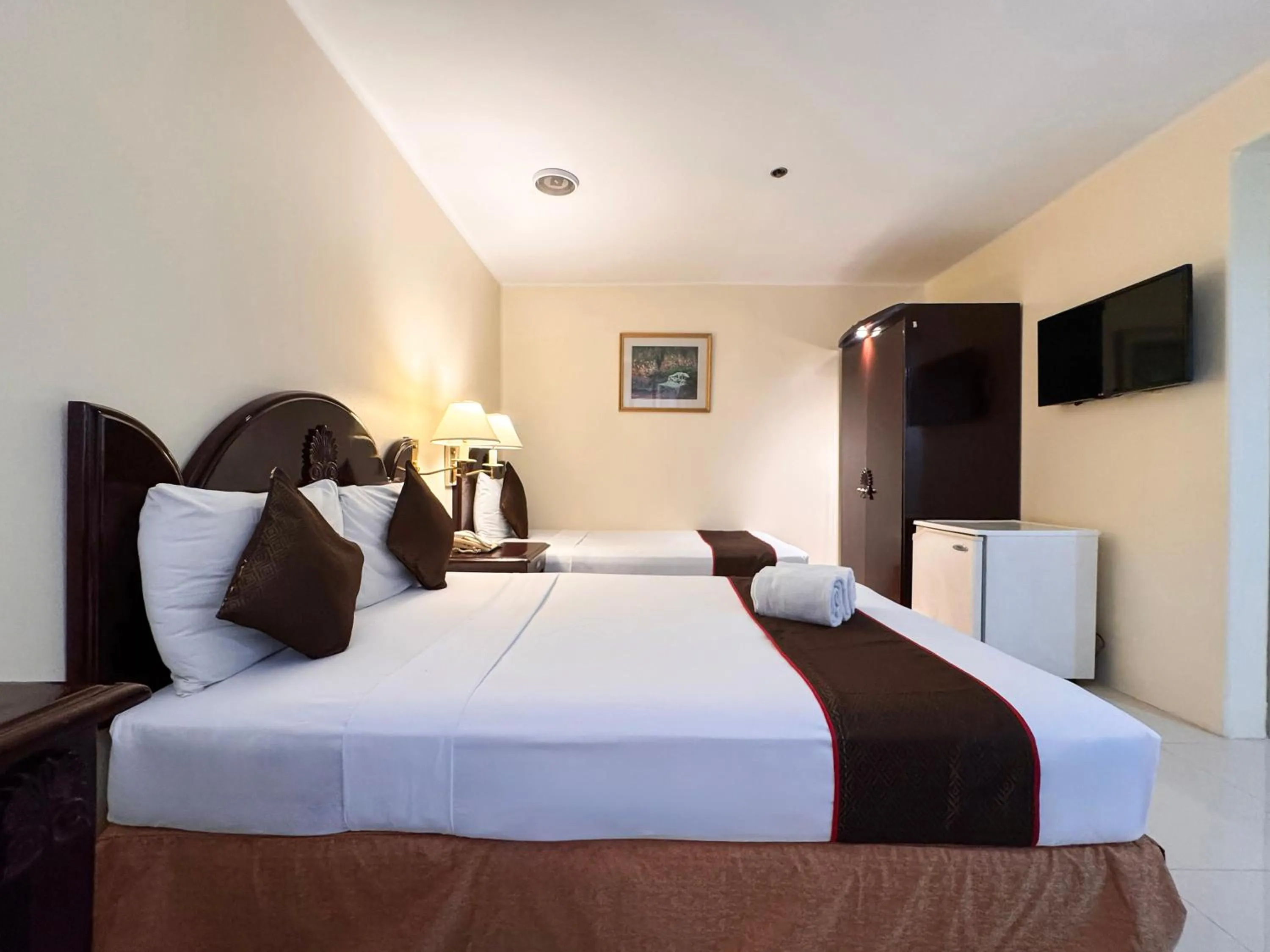 Bed in Palladium Suites Hotel