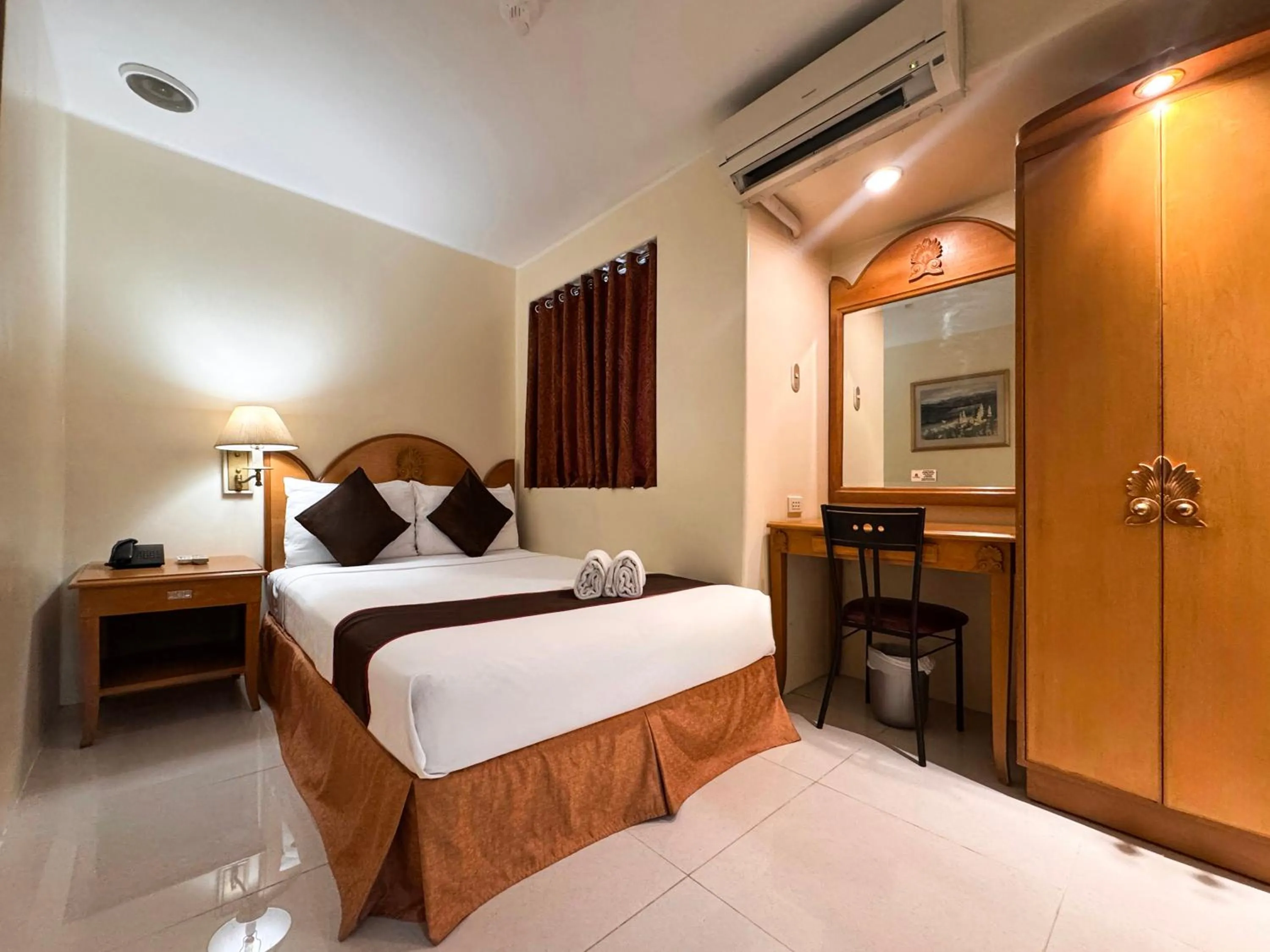 Bed in Palladium Suites Hotel