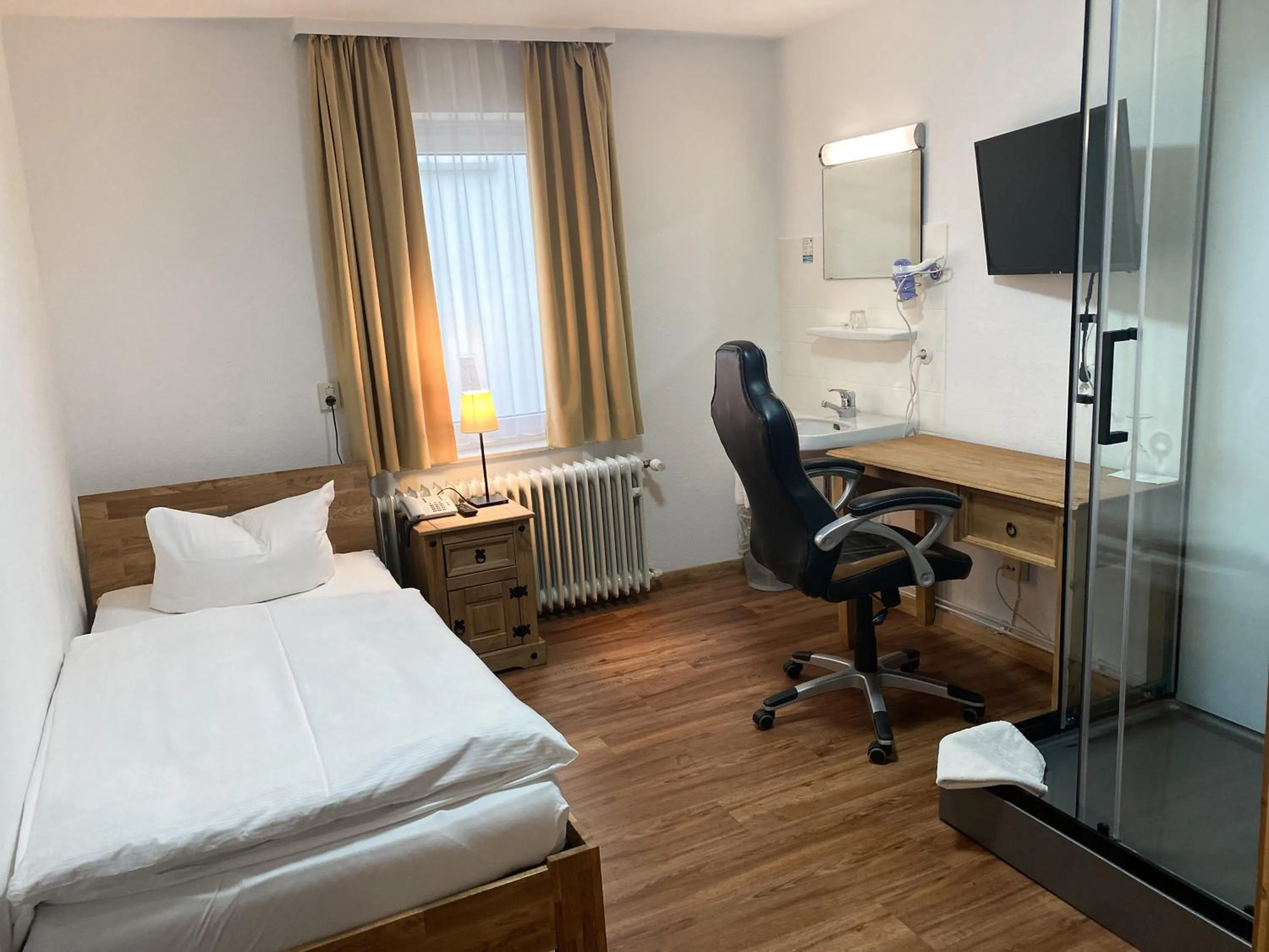 Photo of the whole room, Bed in Hotel Rosengarten Tuttlingen