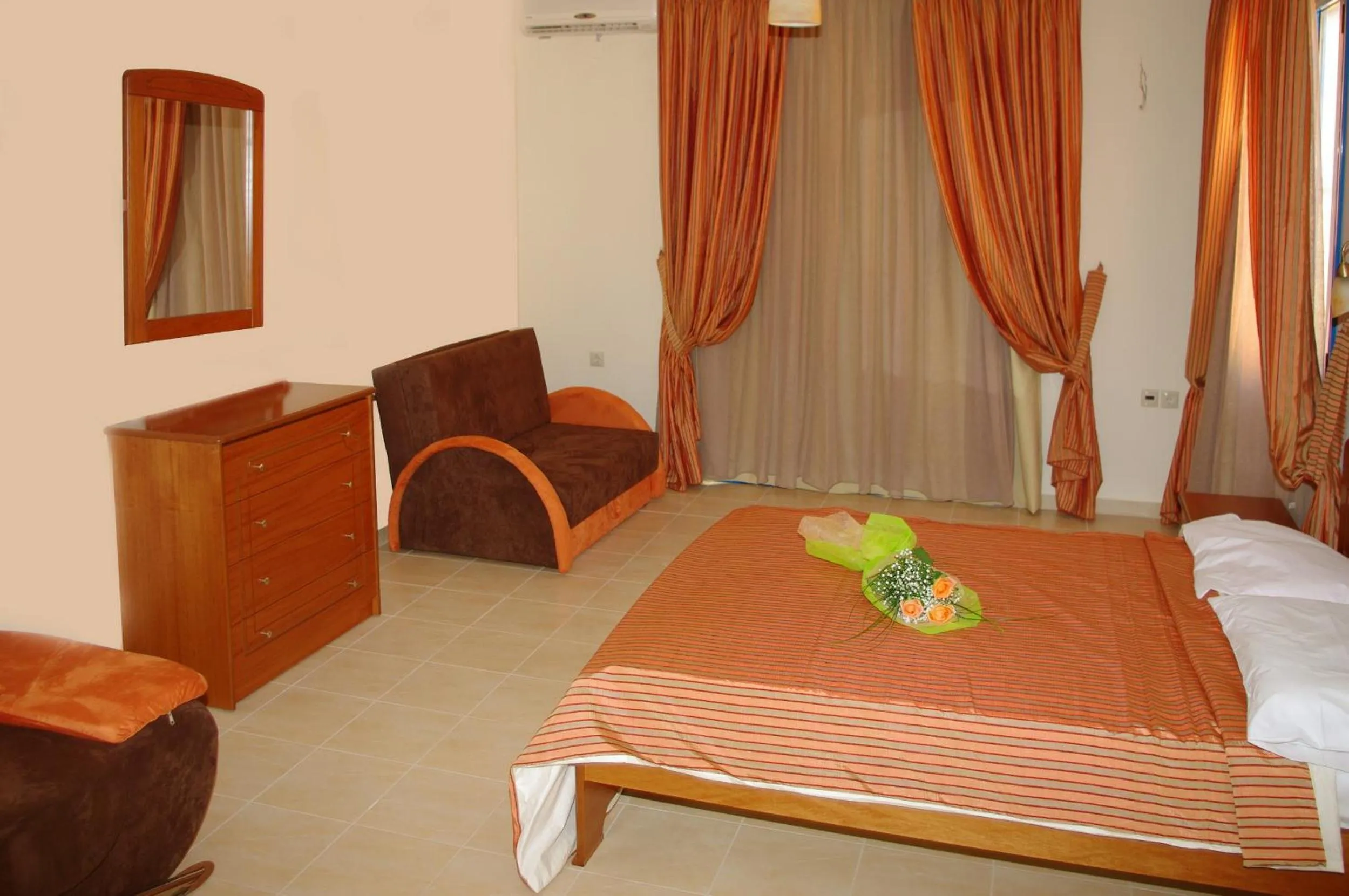 Seating area, Bed in Gold Apartments