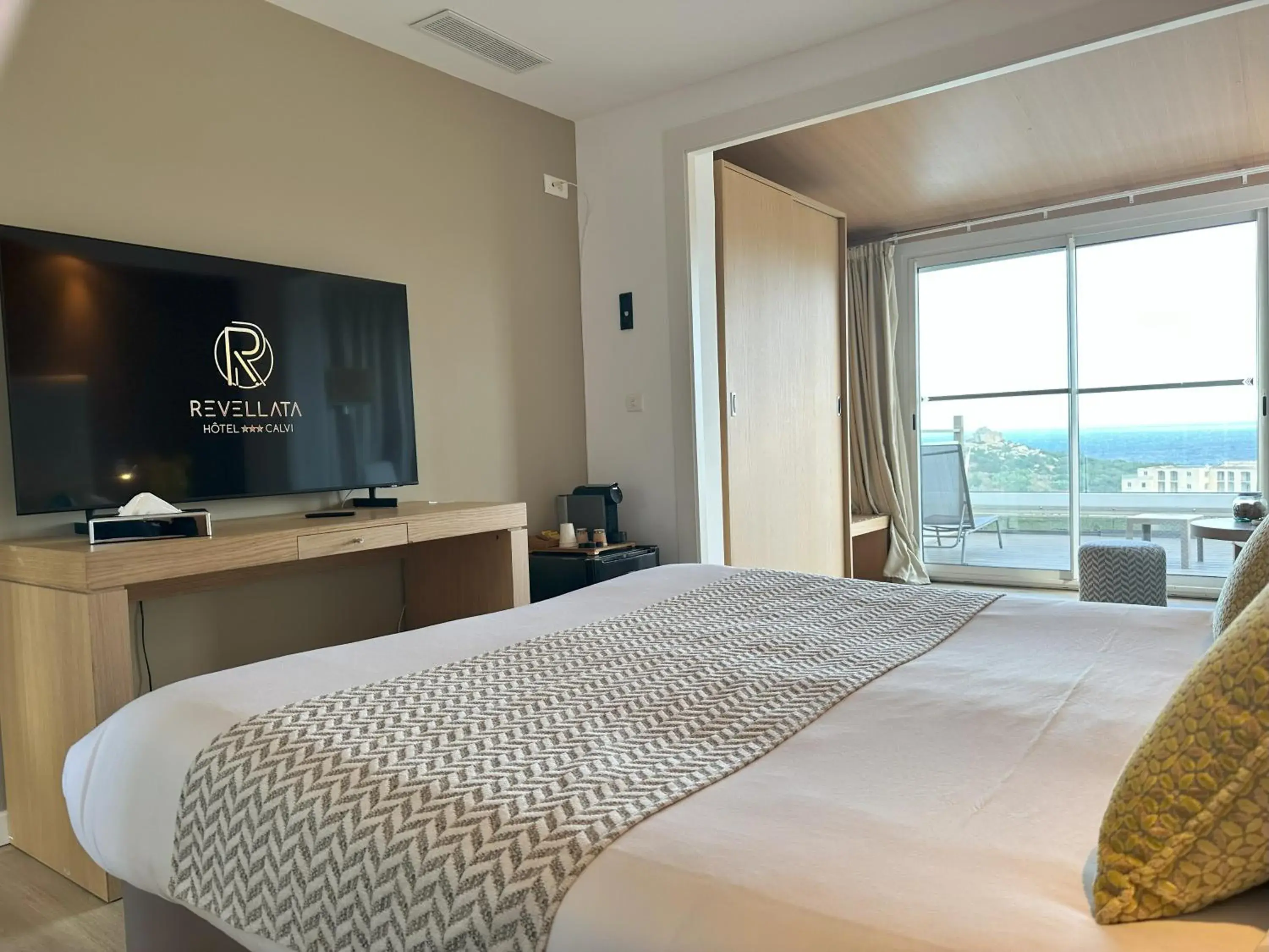 Communal lounge/ TV room, Bed in Hotel Revellata & Spa Communal lounge/ TV room, Bed in Hotel Revellata & Spa