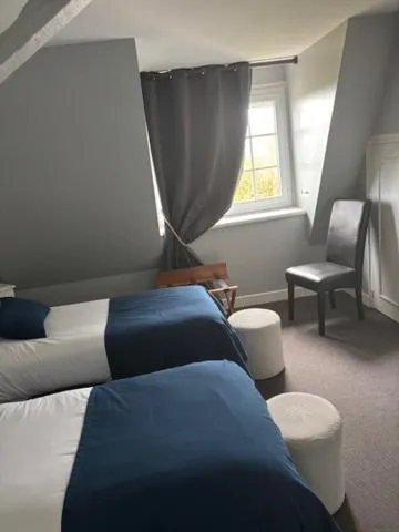 Bed in Logis Hôtel de la Tour