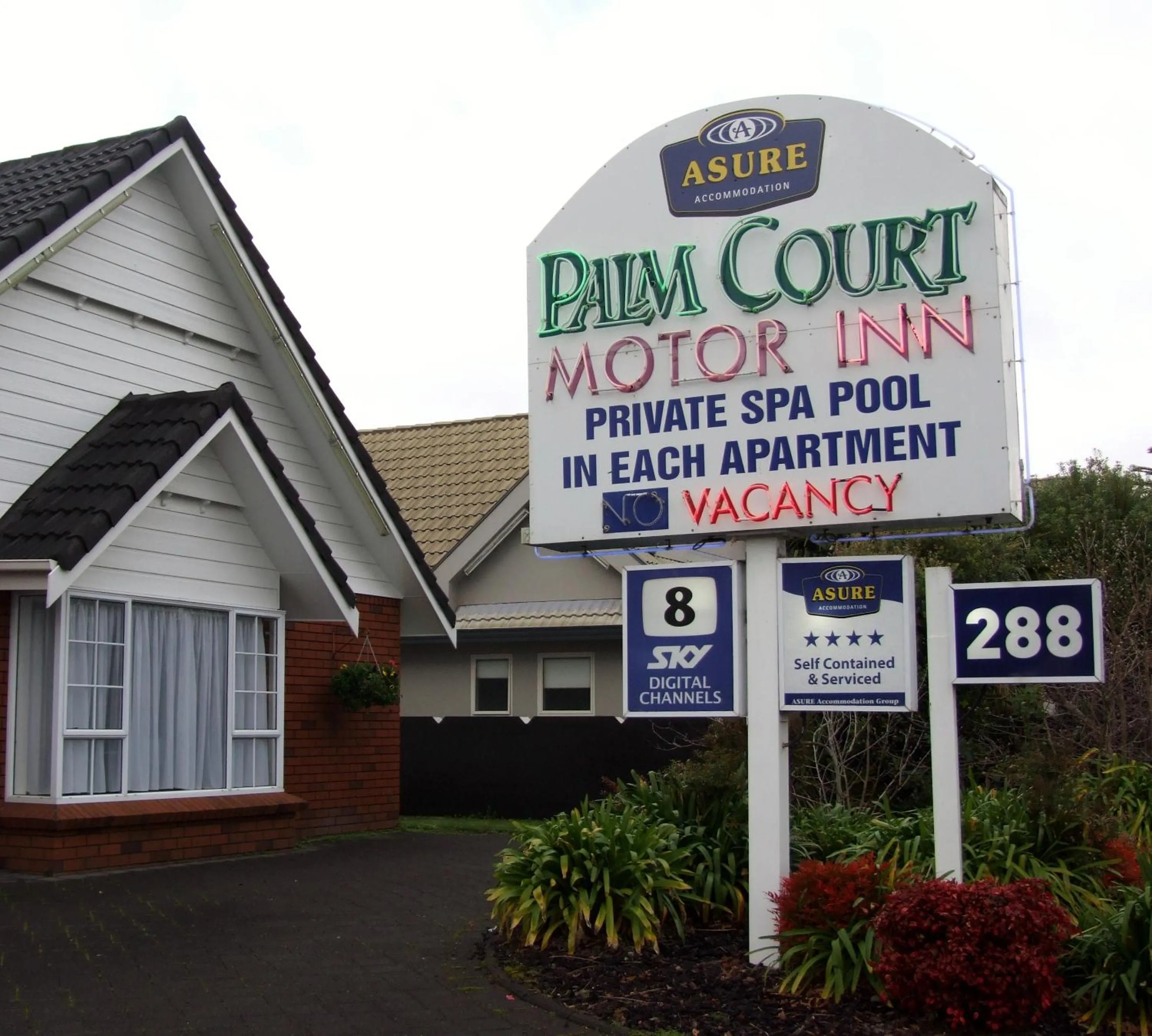 Property logo or sign in Palm Court Motor Inn