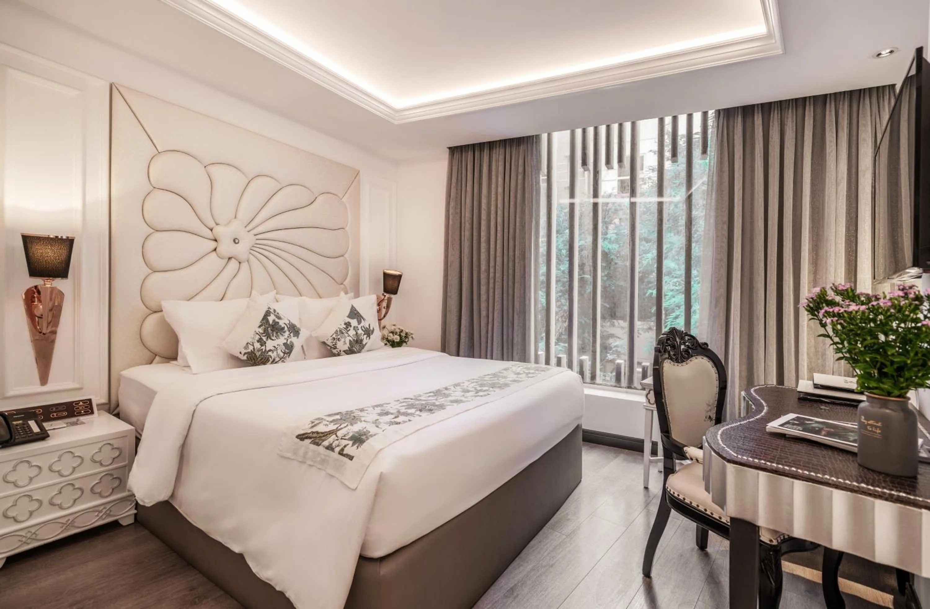 Bed in A&EM Saigon Hotel