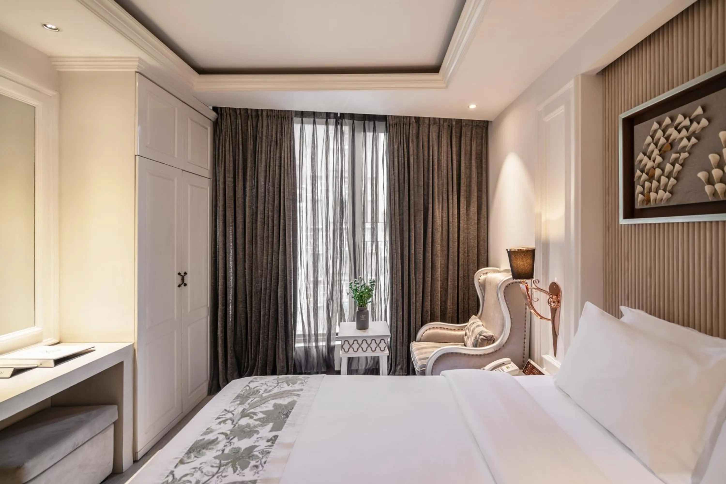 Bed in A&EM Saigon Hotel