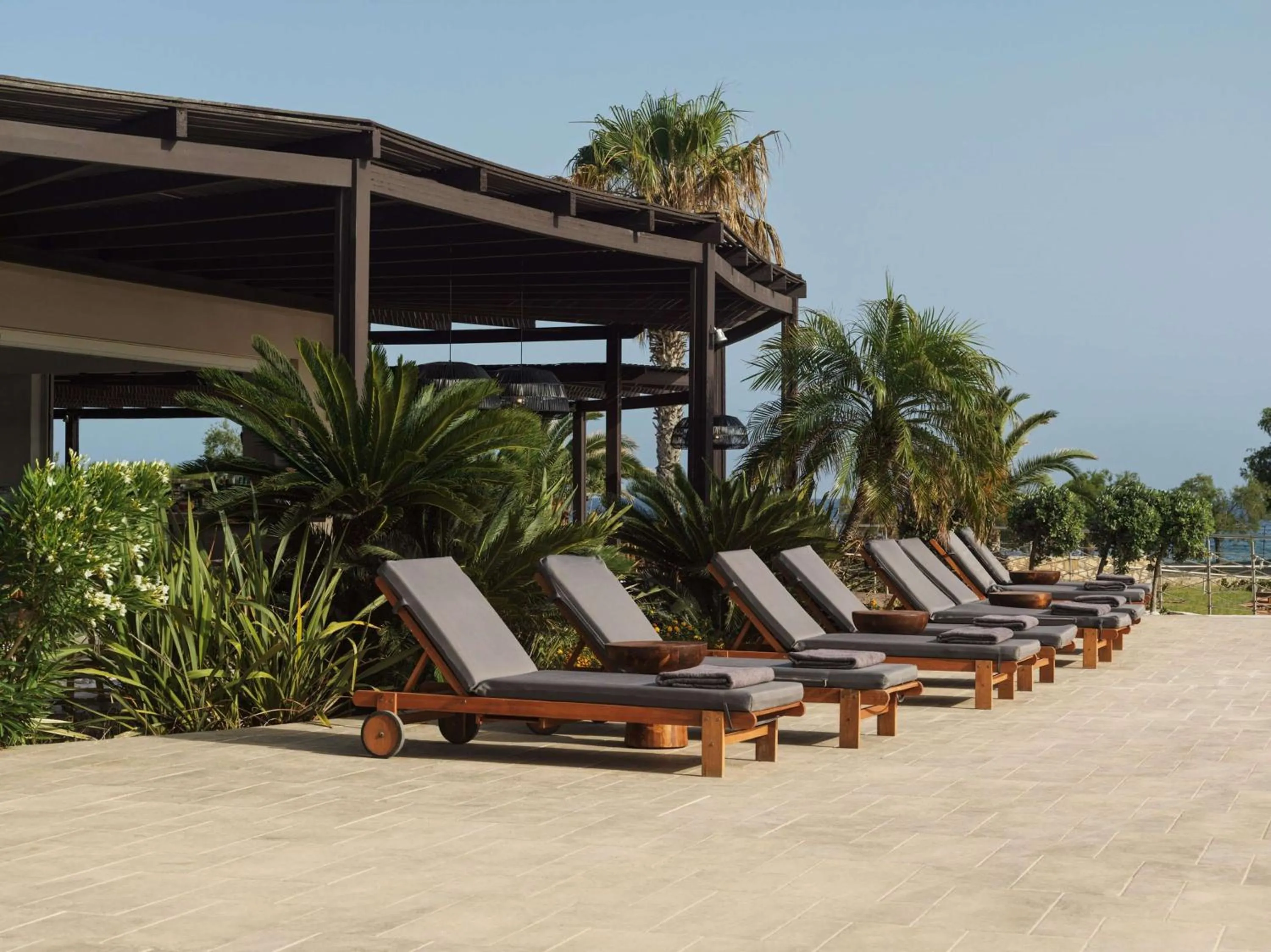 Pool view in Lindian Village, Curio Collection by Hilton