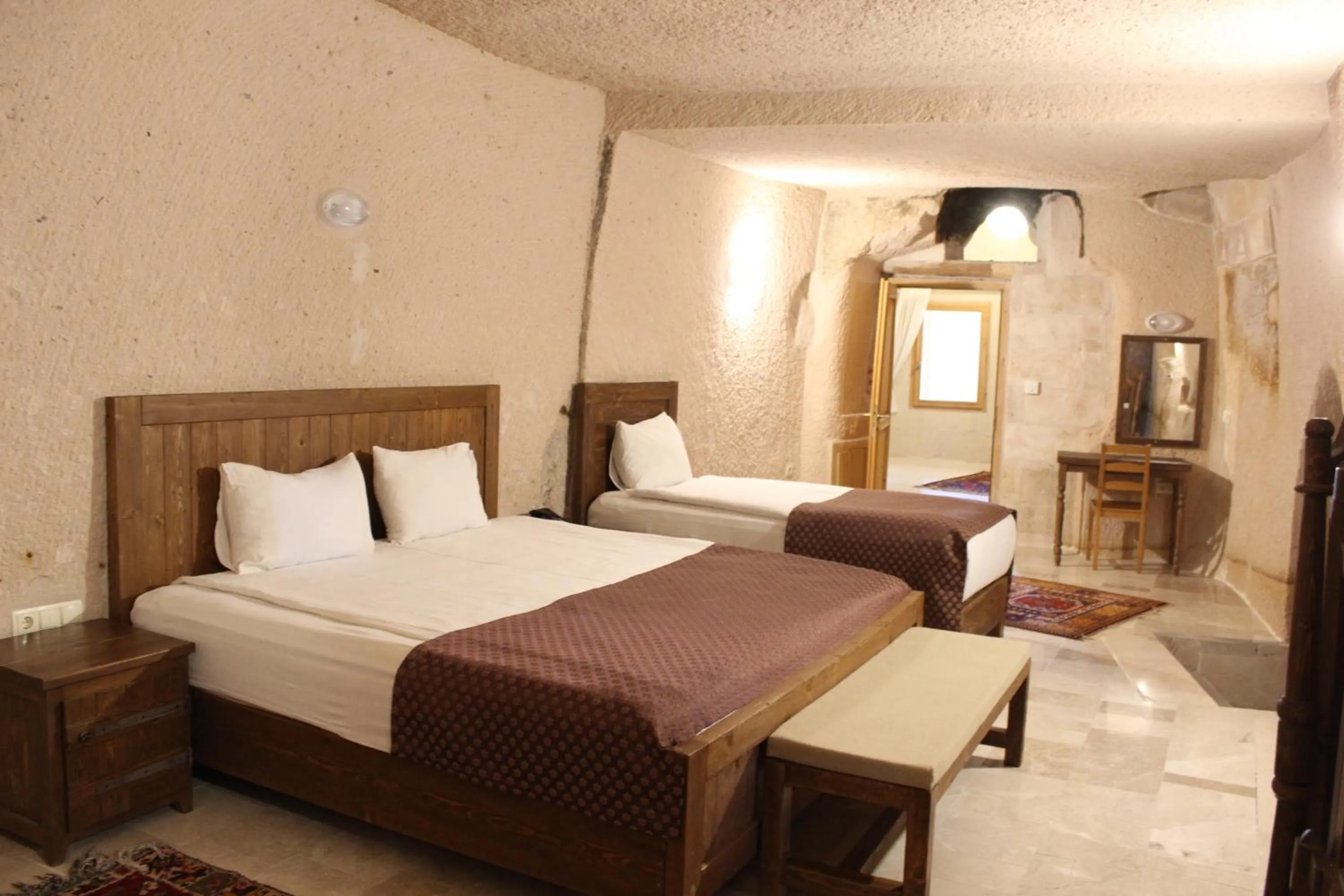 Bed in Helike Cave Suites