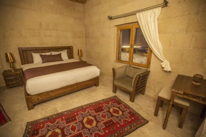 Bed in Helike Cave Suites