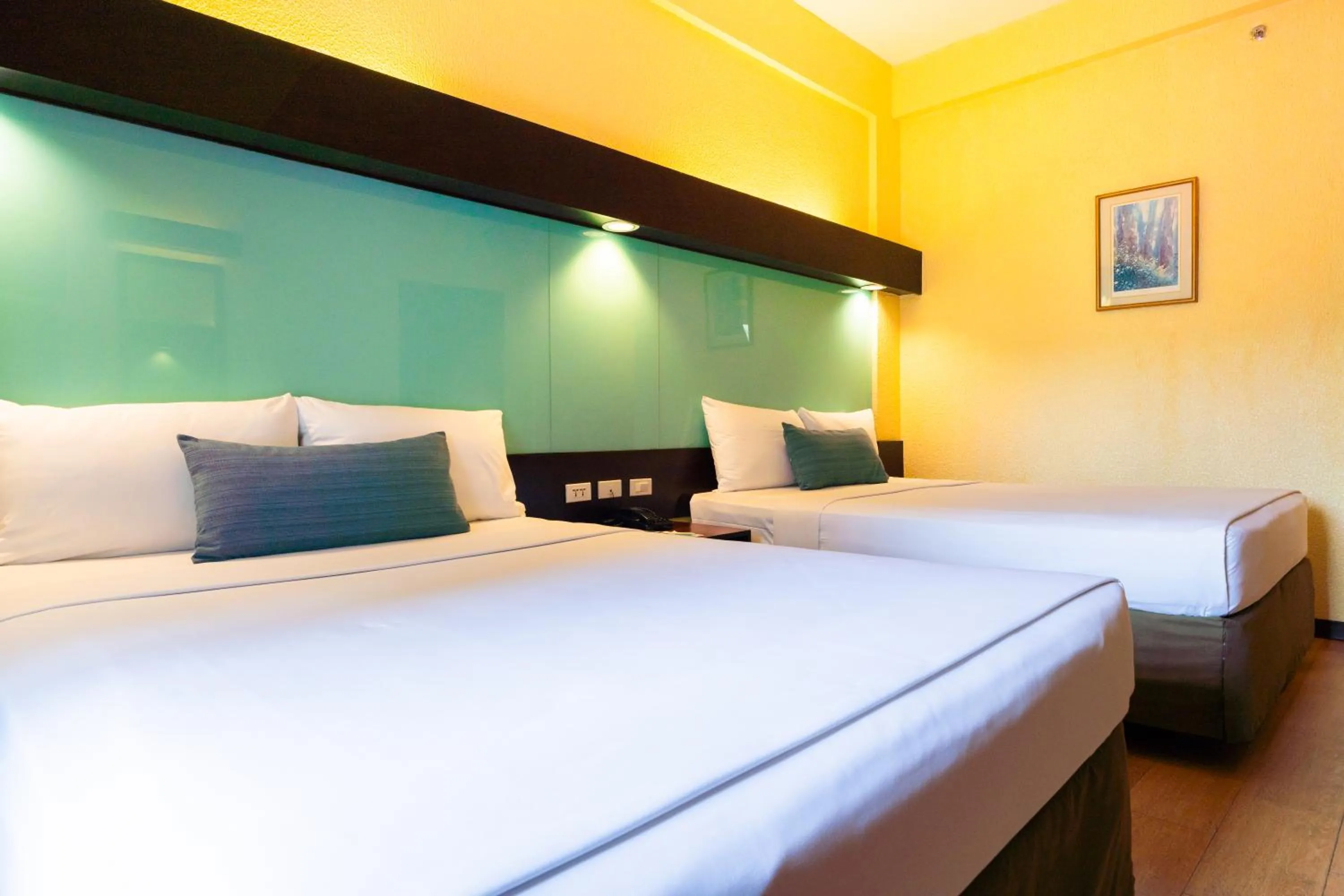 Bed in Microtel by Wyndham Cabanatuan