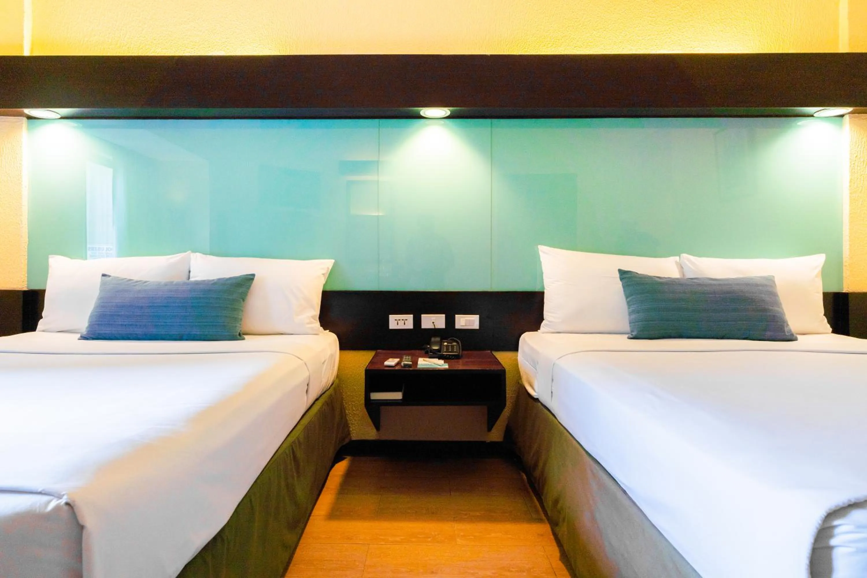 Bed in Microtel by Wyndham Cabanatuan