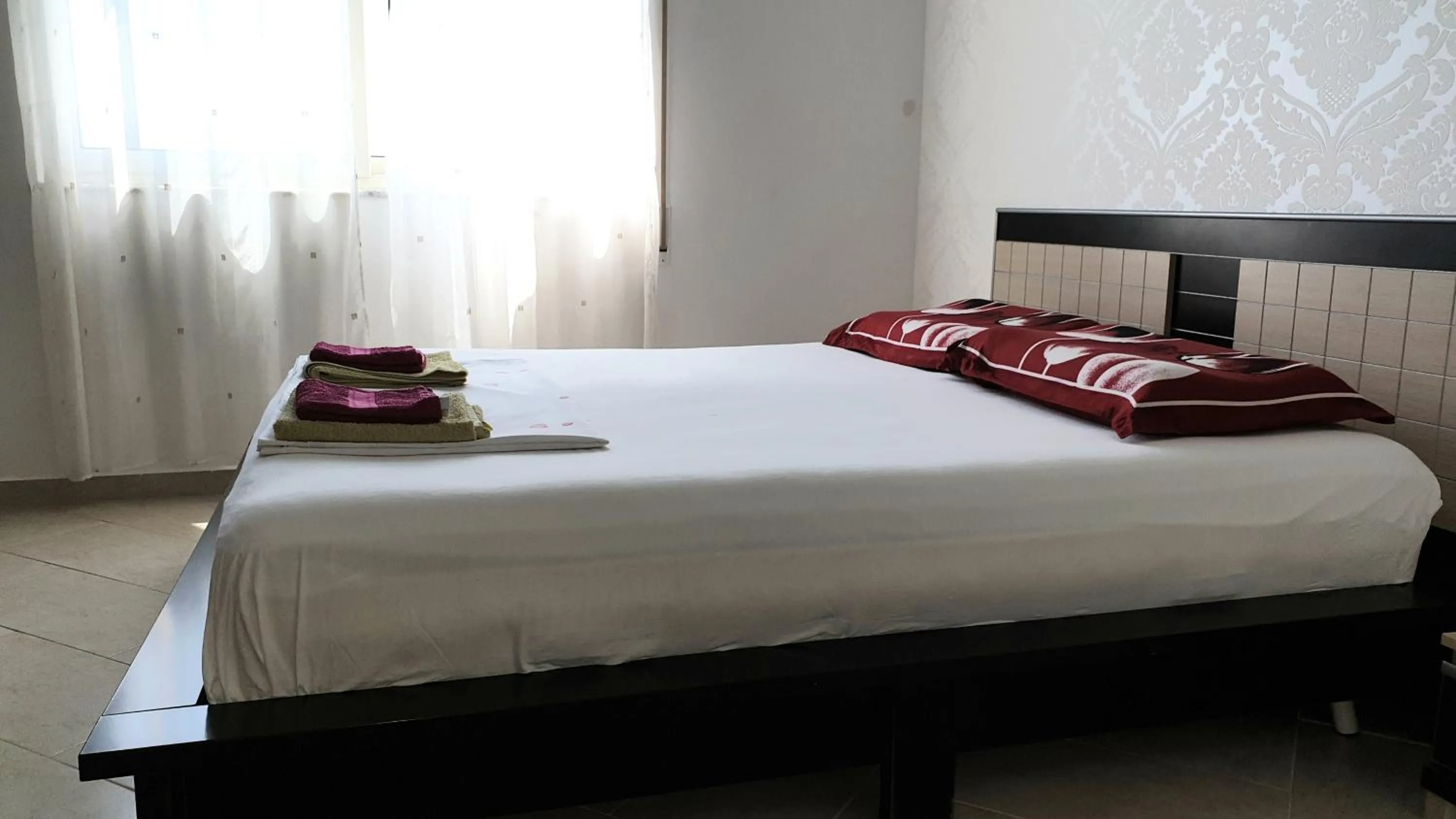 Bed in M&I Beach Apartment with Sea View