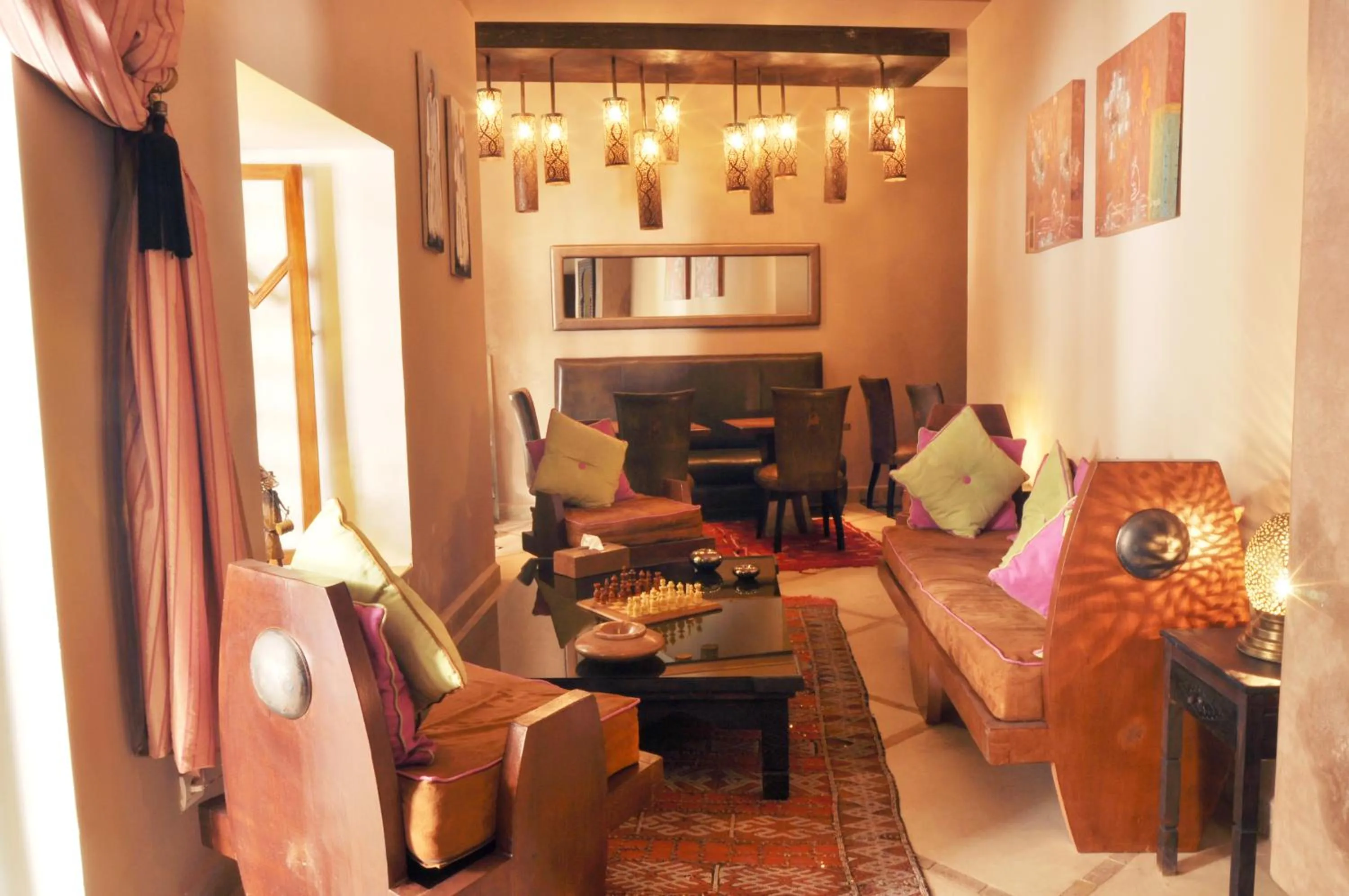 Communal lounge/ TV room in Riad Jardin Des Rêves