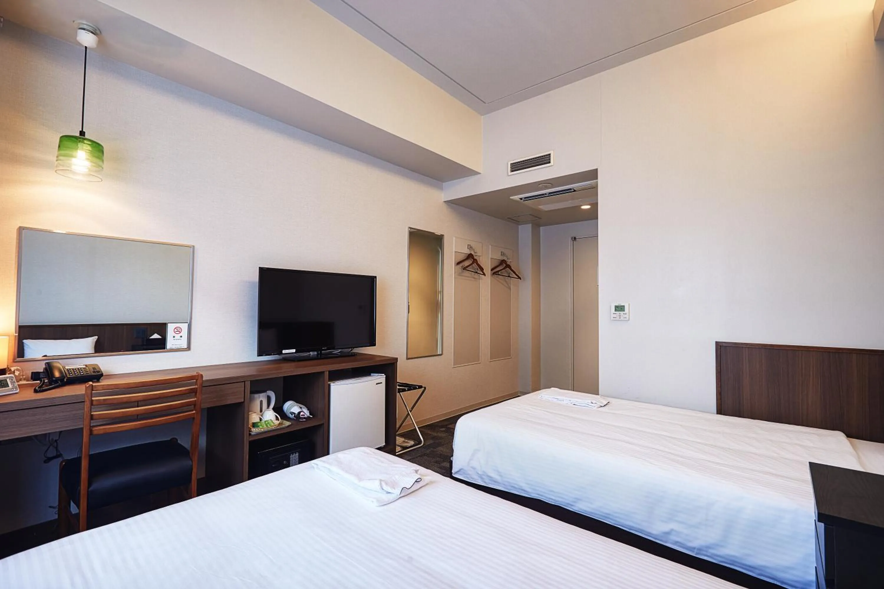 Bed in RJ Hotel Naha