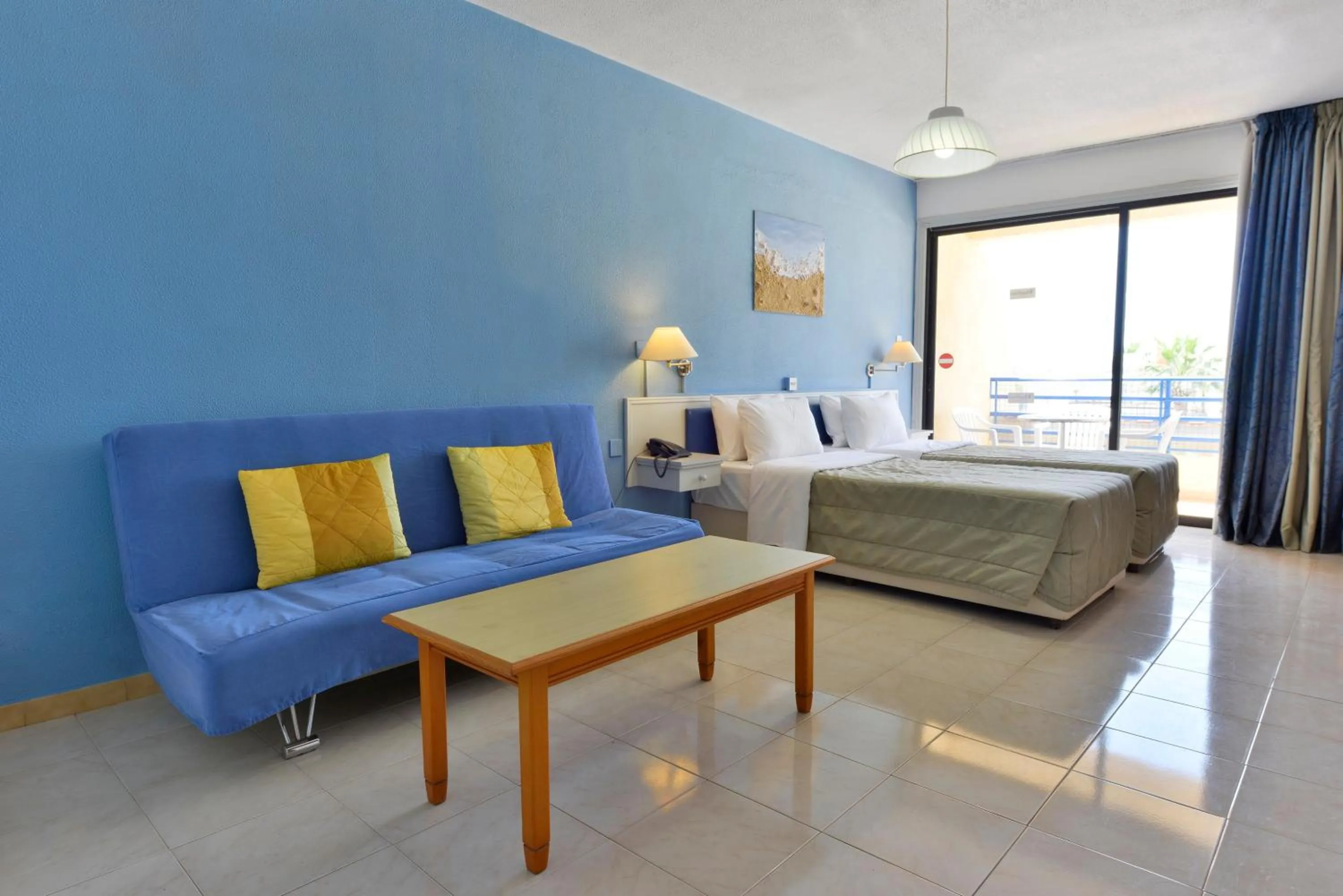 Seating area, Bed in Napa Prince Hotel Apts