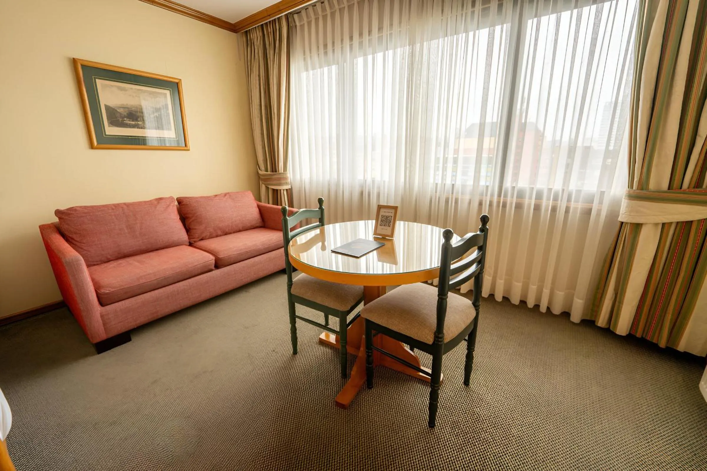 Photo of the whole room in abba Presidente Suites Puerto Montt
