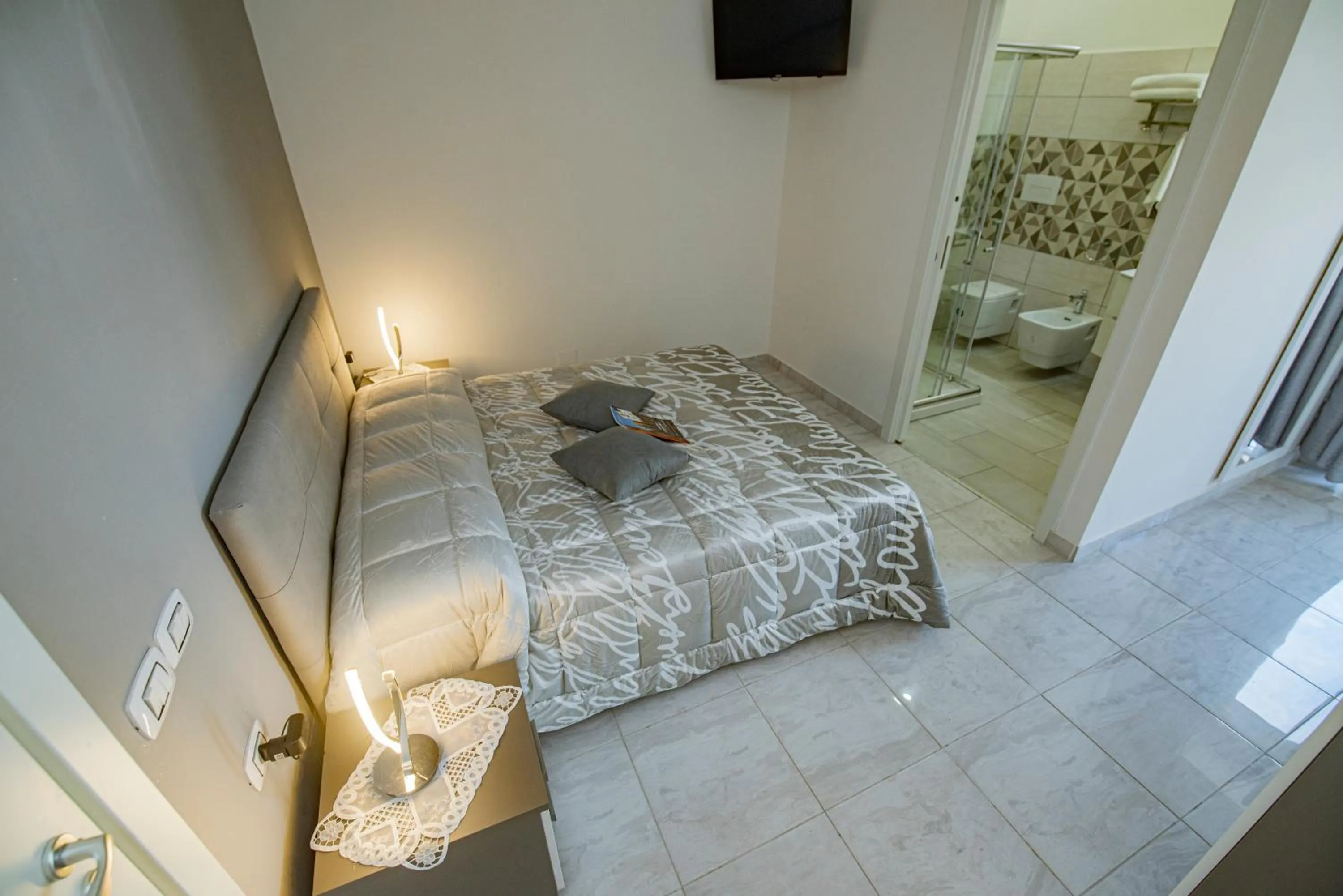 Bed in L'Isola Del Postino Rooms