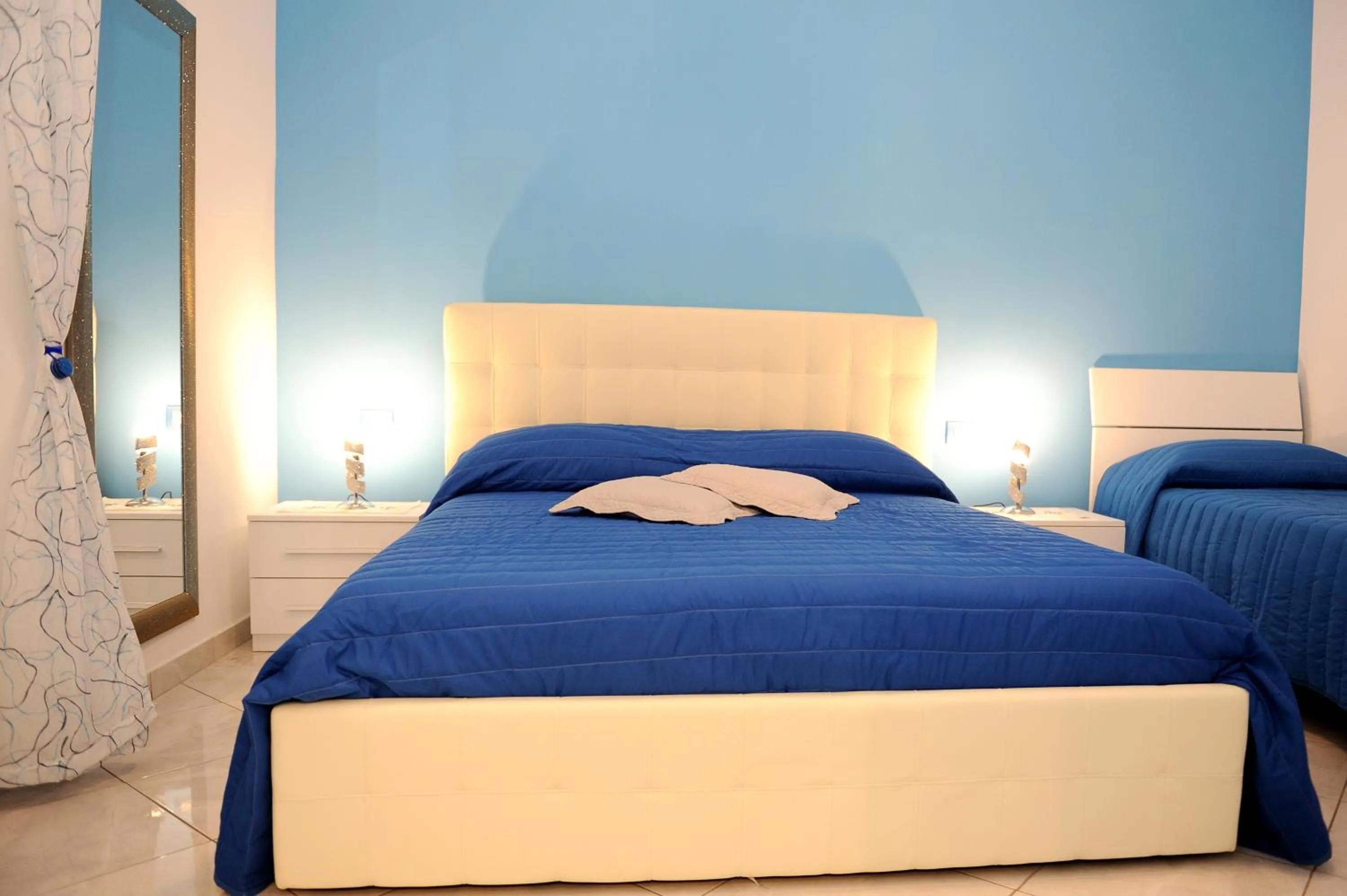 Bed in L'Isola Del Postino Rooms