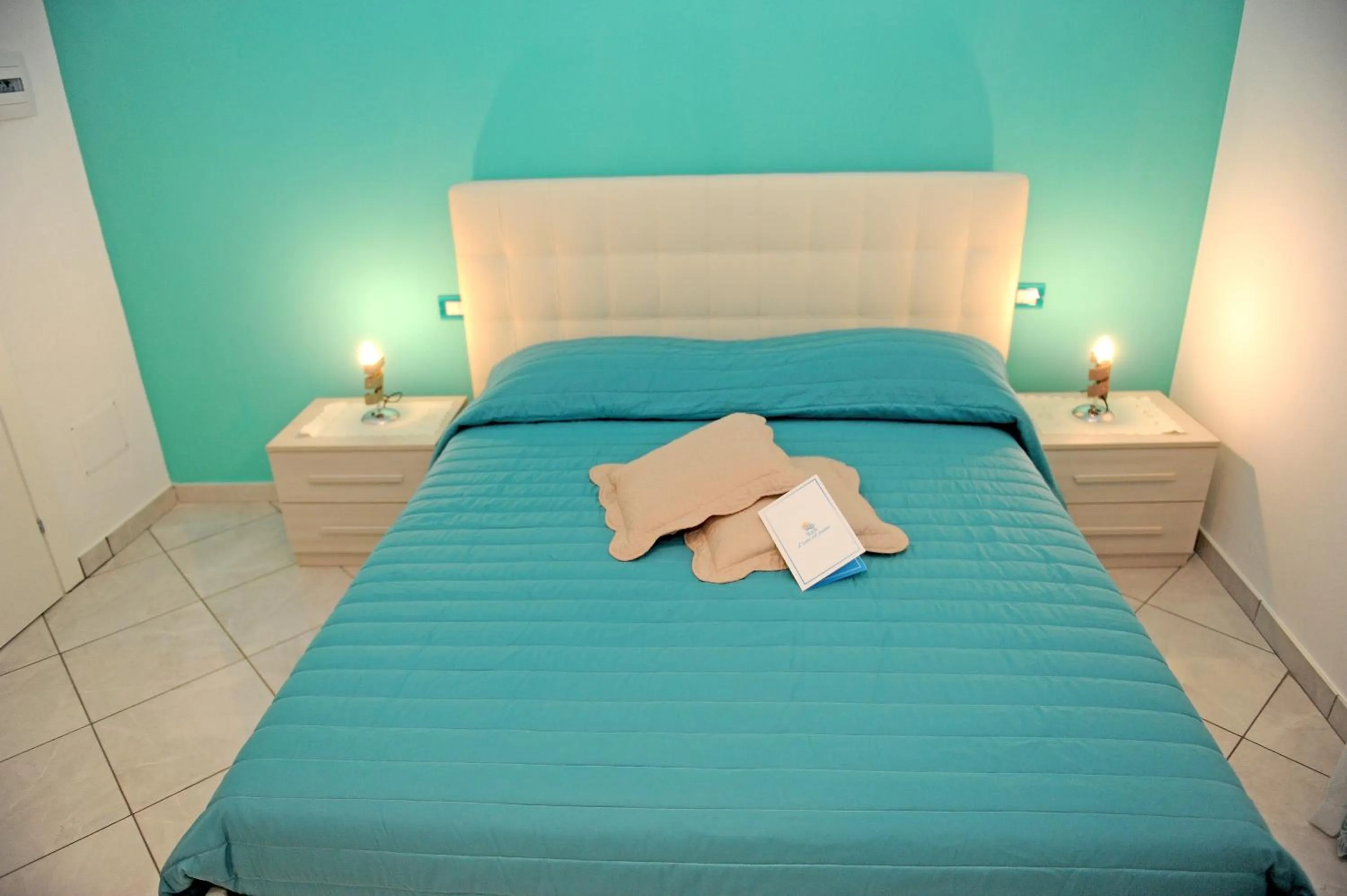 Bed in L'Isola Del Postino Rooms