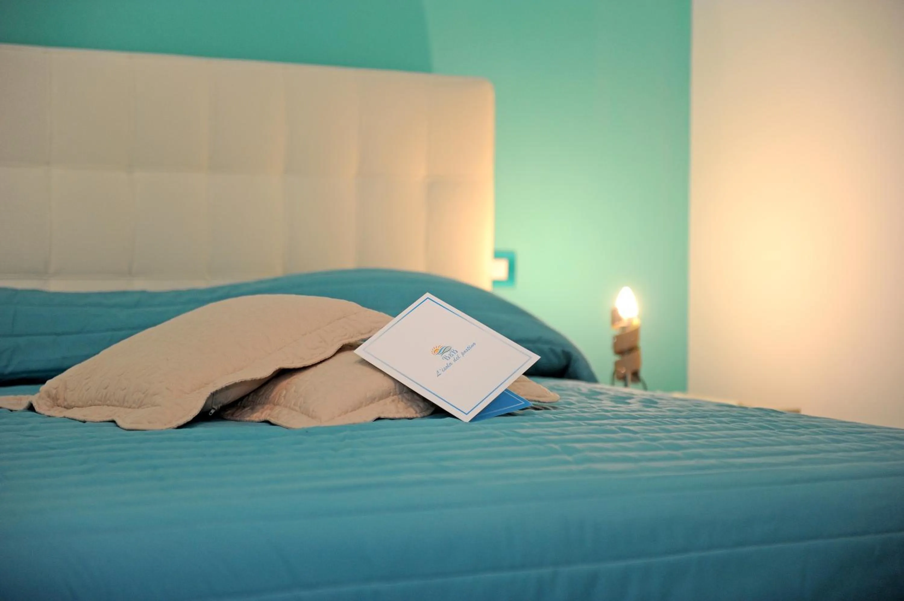 Bed in L'Isola Del Postino Rooms