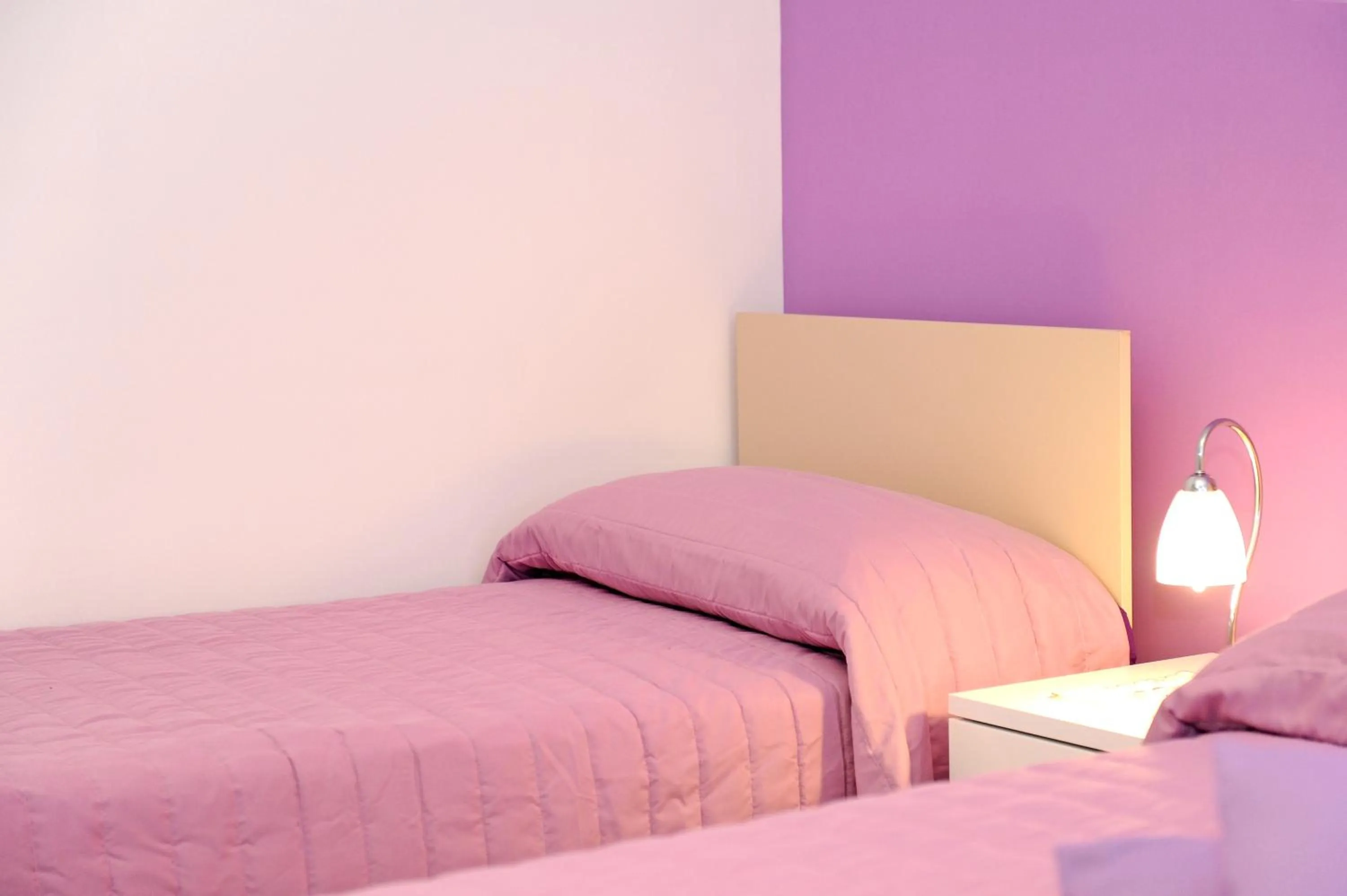 Bed in L'Isola Del Postino Rooms