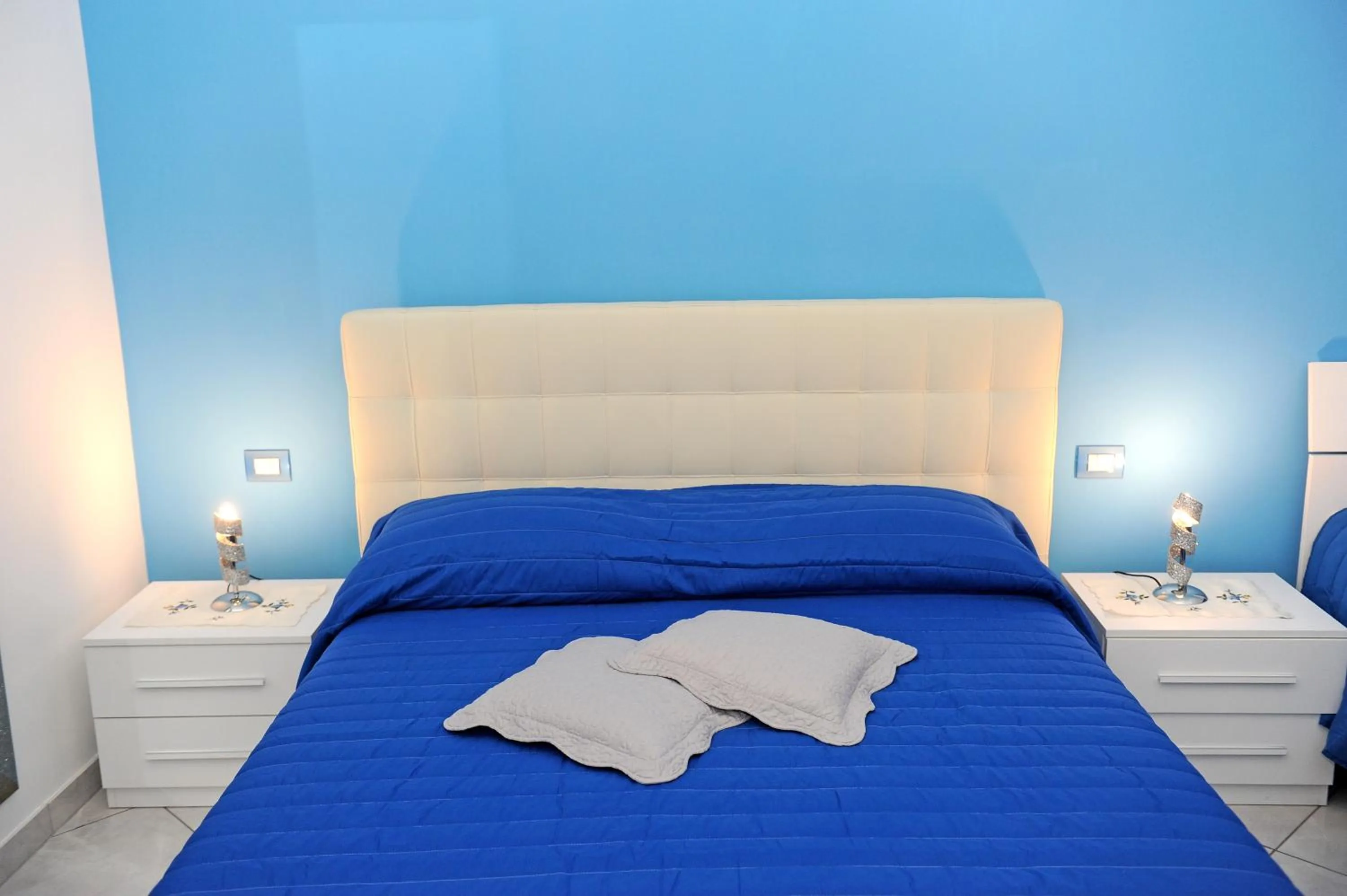 Bed in L'Isola Del Postino Rooms