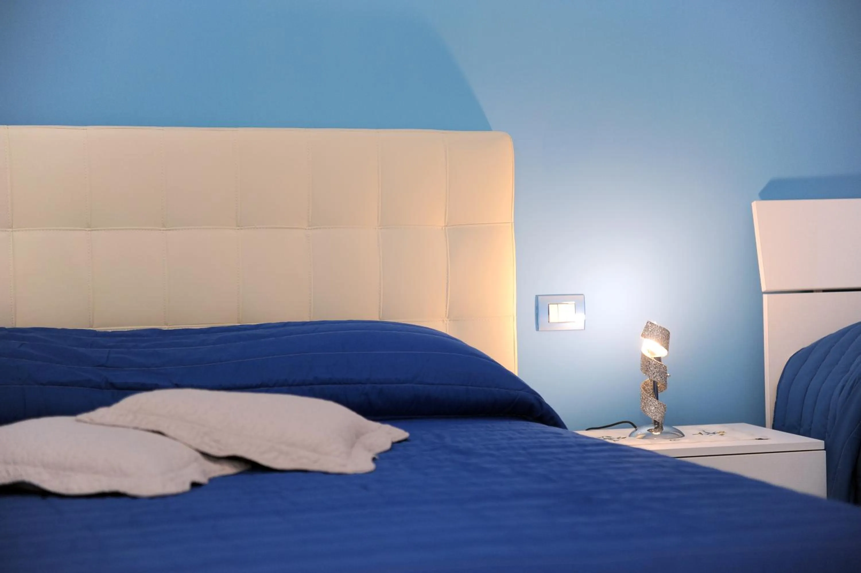 Bed in L'Isola Del Postino Rooms