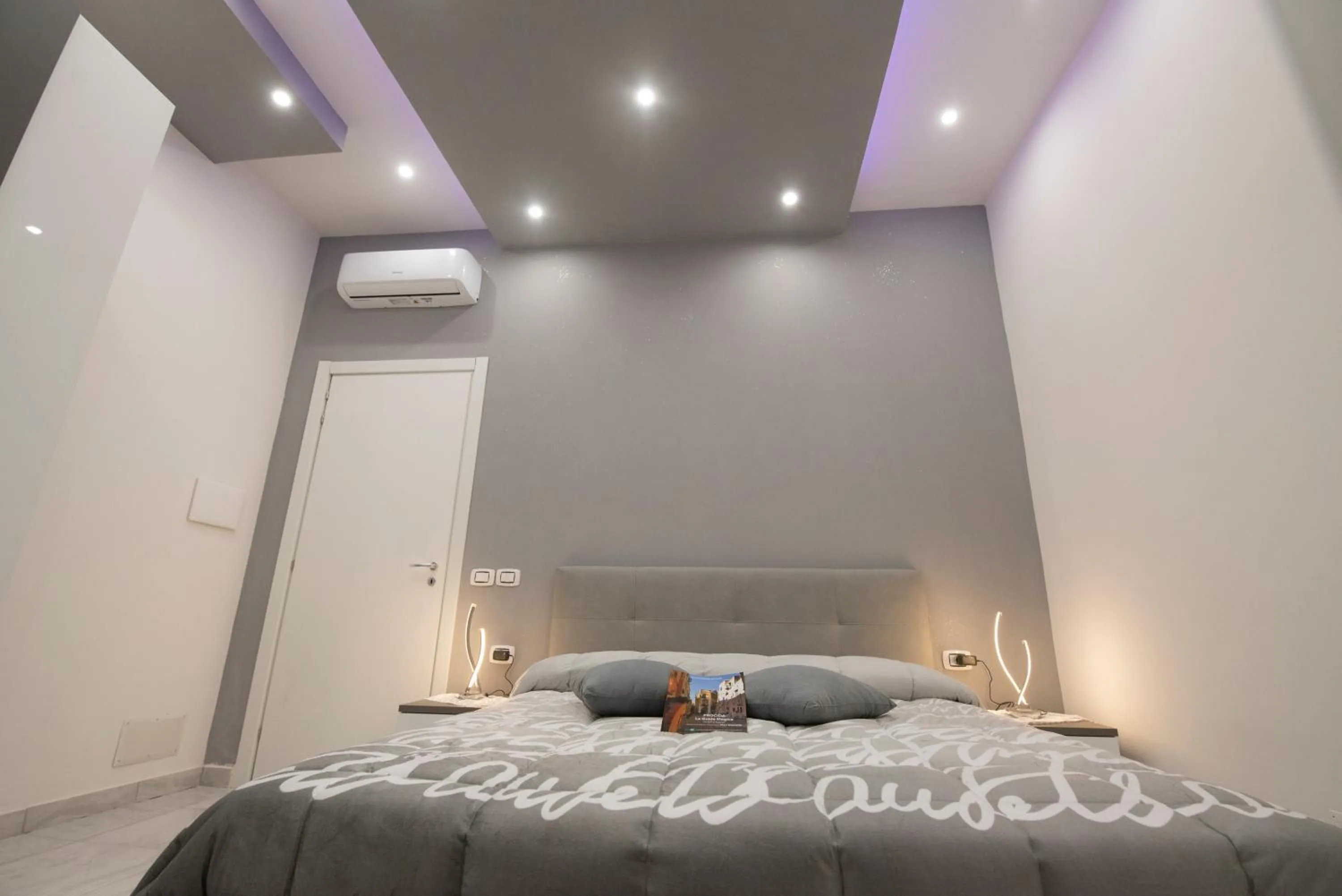 Bed in L'Isola Del Postino Rooms