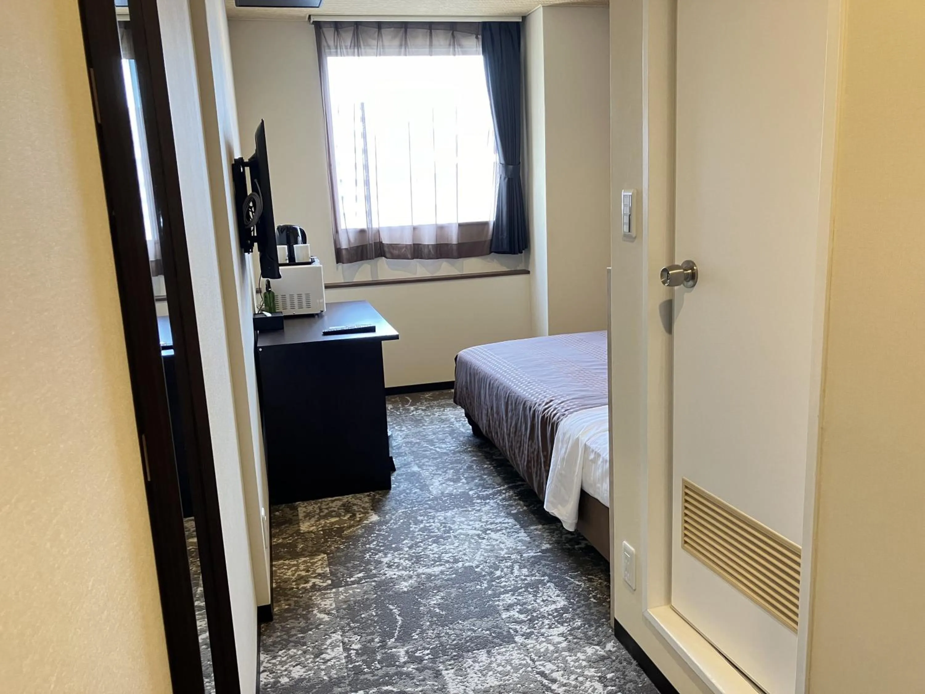 Bed in HOTEL LiVEMAX BUDGET Shinosaka