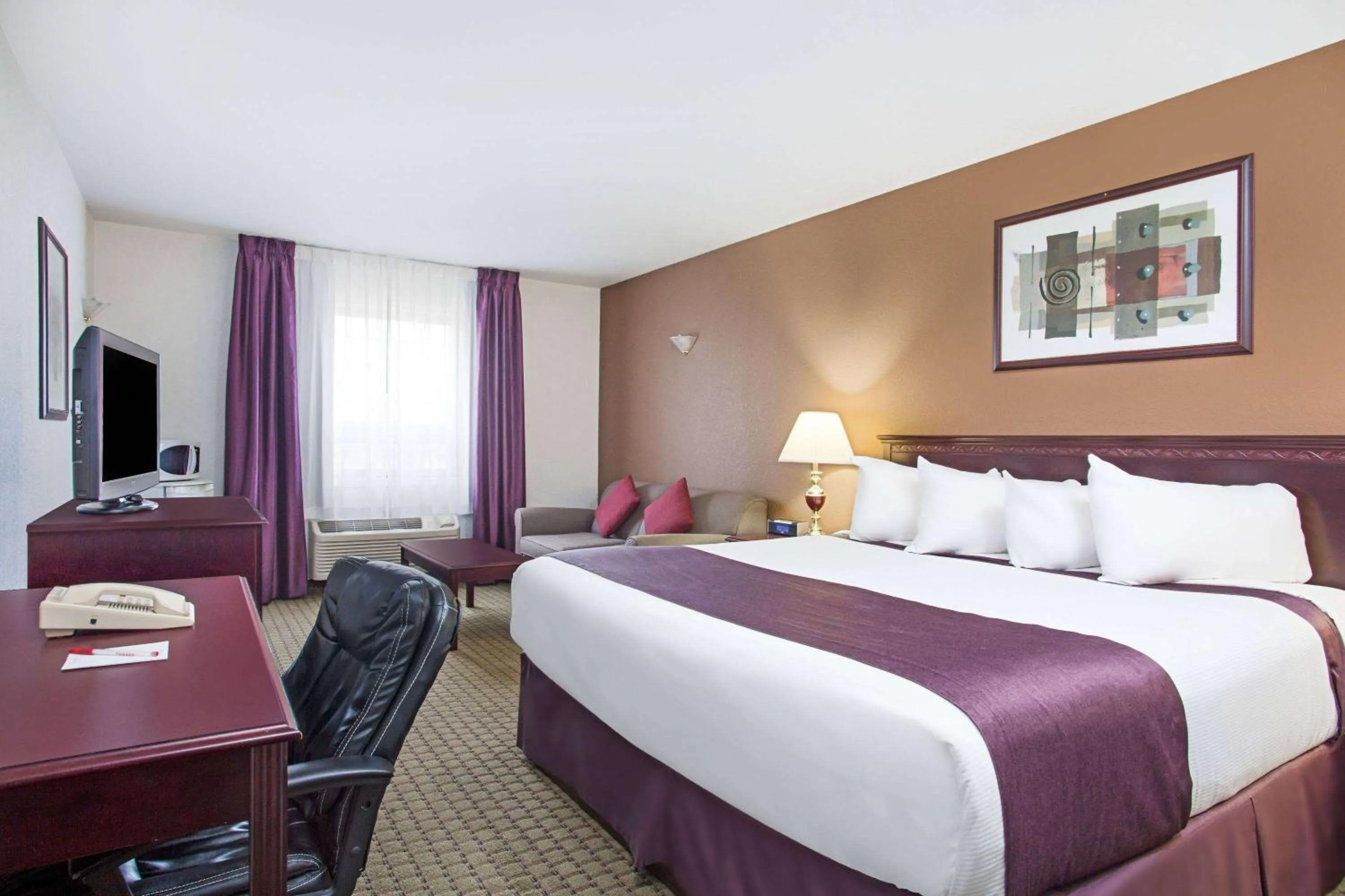 Bed in Ramada by Wyndham Red Deer Hotel & Suites
