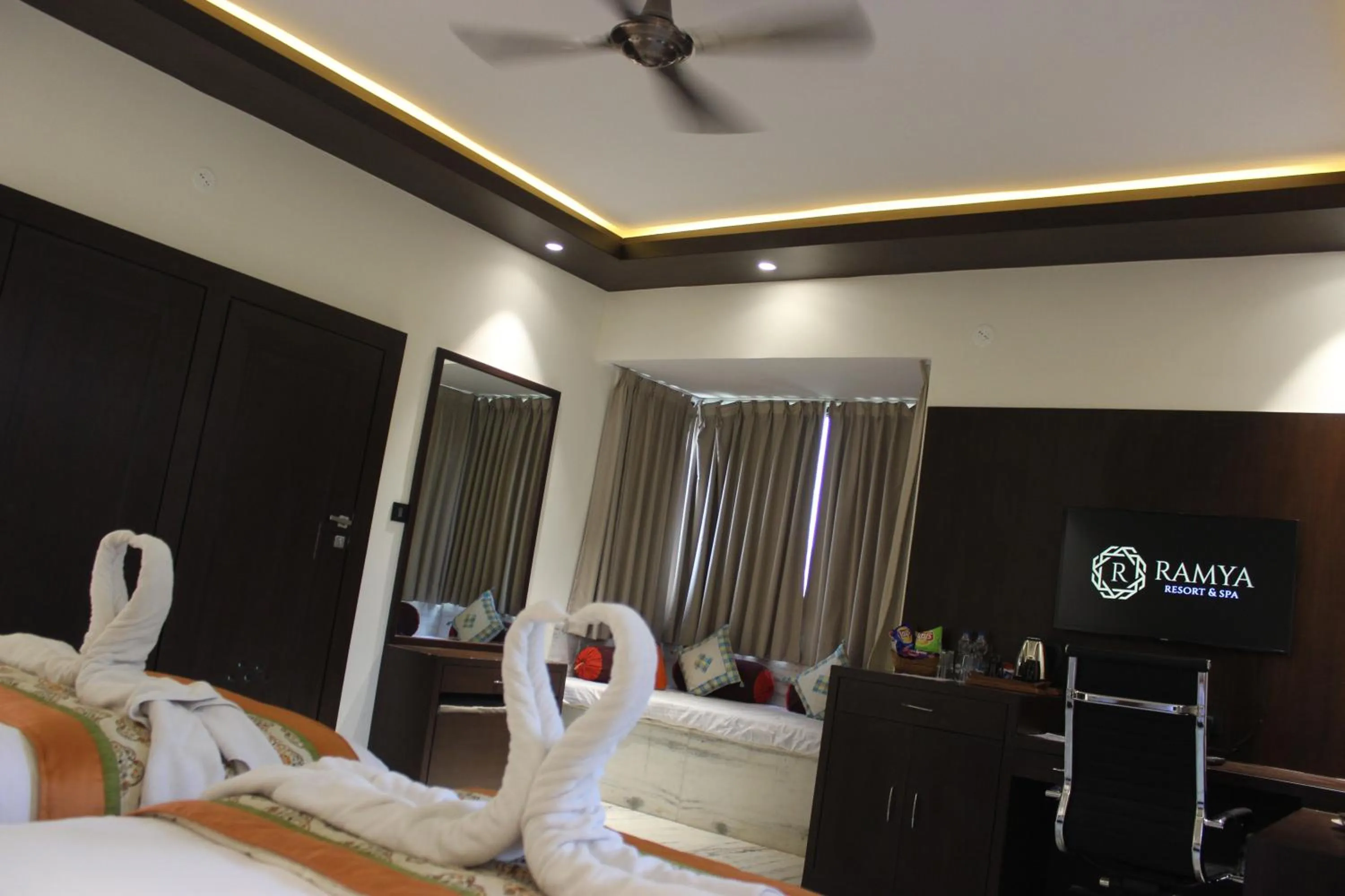 Seating area, Bed in Ramya Resort & Spa