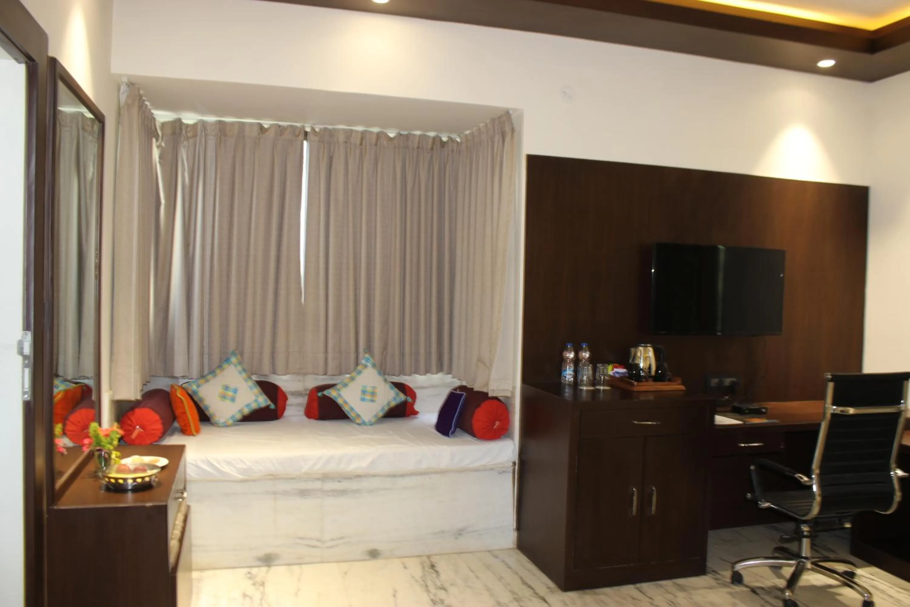 Seating area, Bed in Ramya Resort & Spa