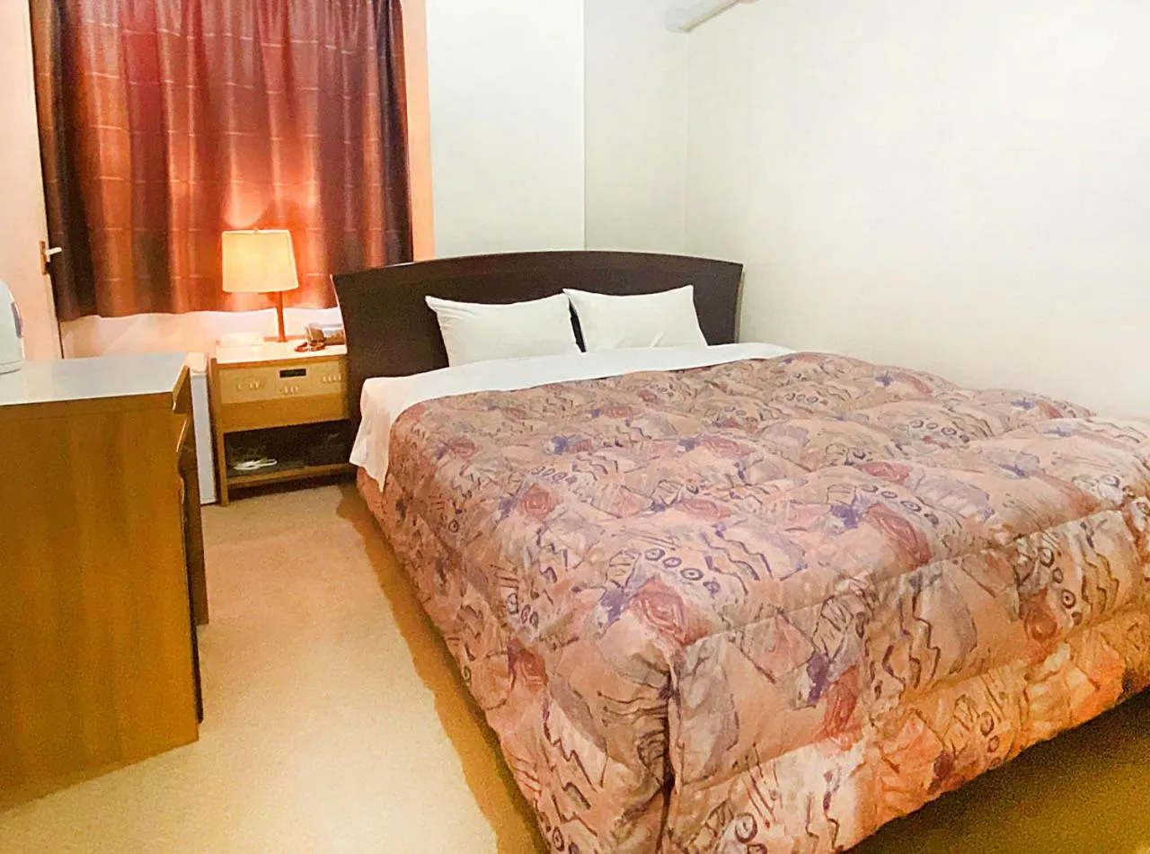 Photo of the whole room, Bed in Hotel Okuni (Royal Inn Group)