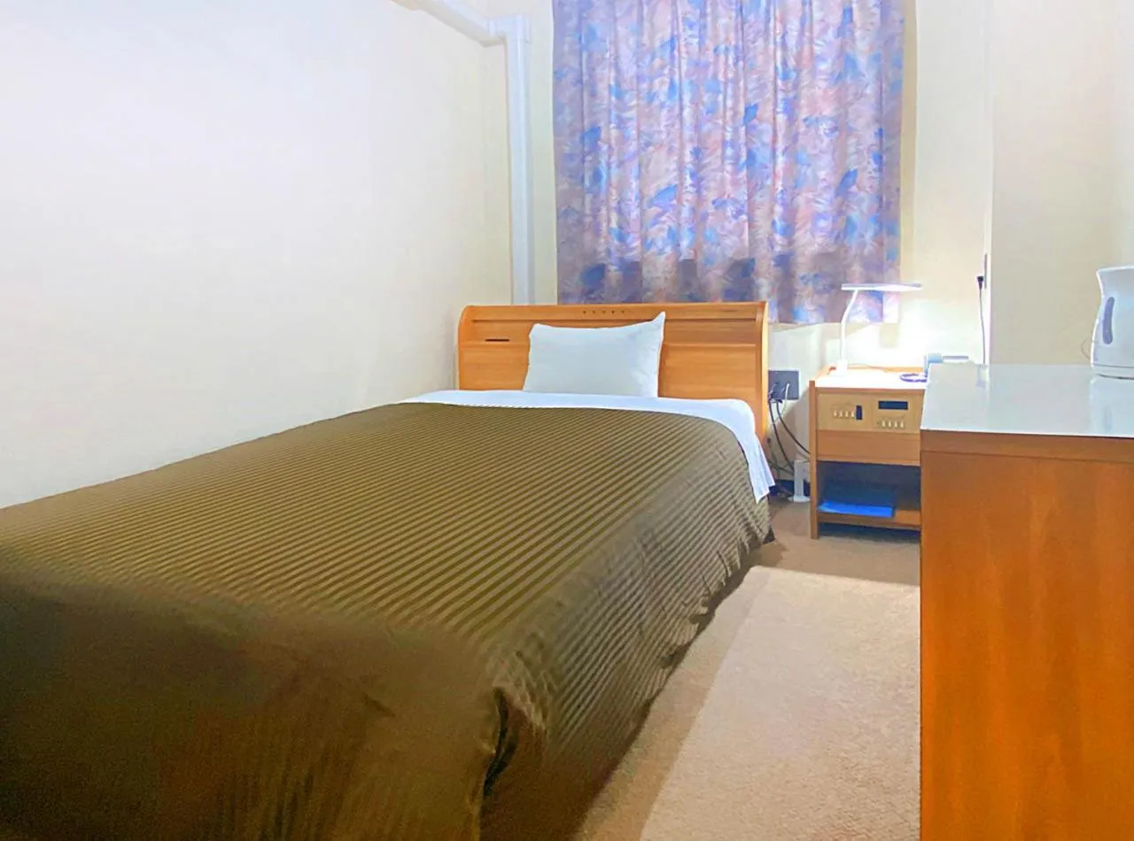 Photo of the whole room, Bed in Hotel Okuni (Royal Inn Group)