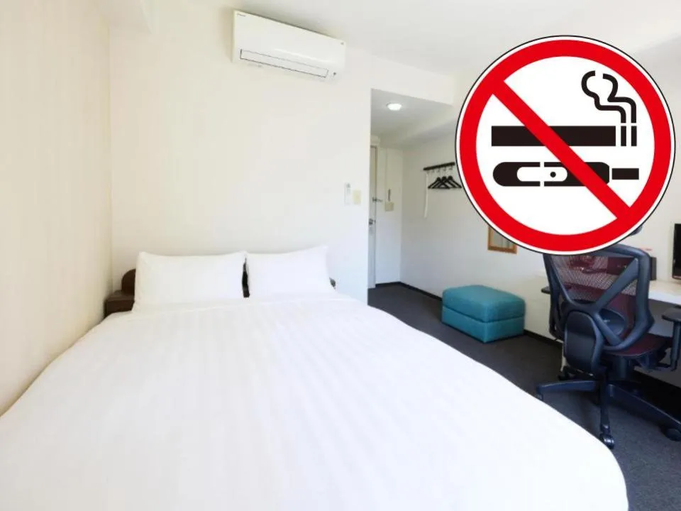 Bed in Tabist HotelArflex Tokuyama Station