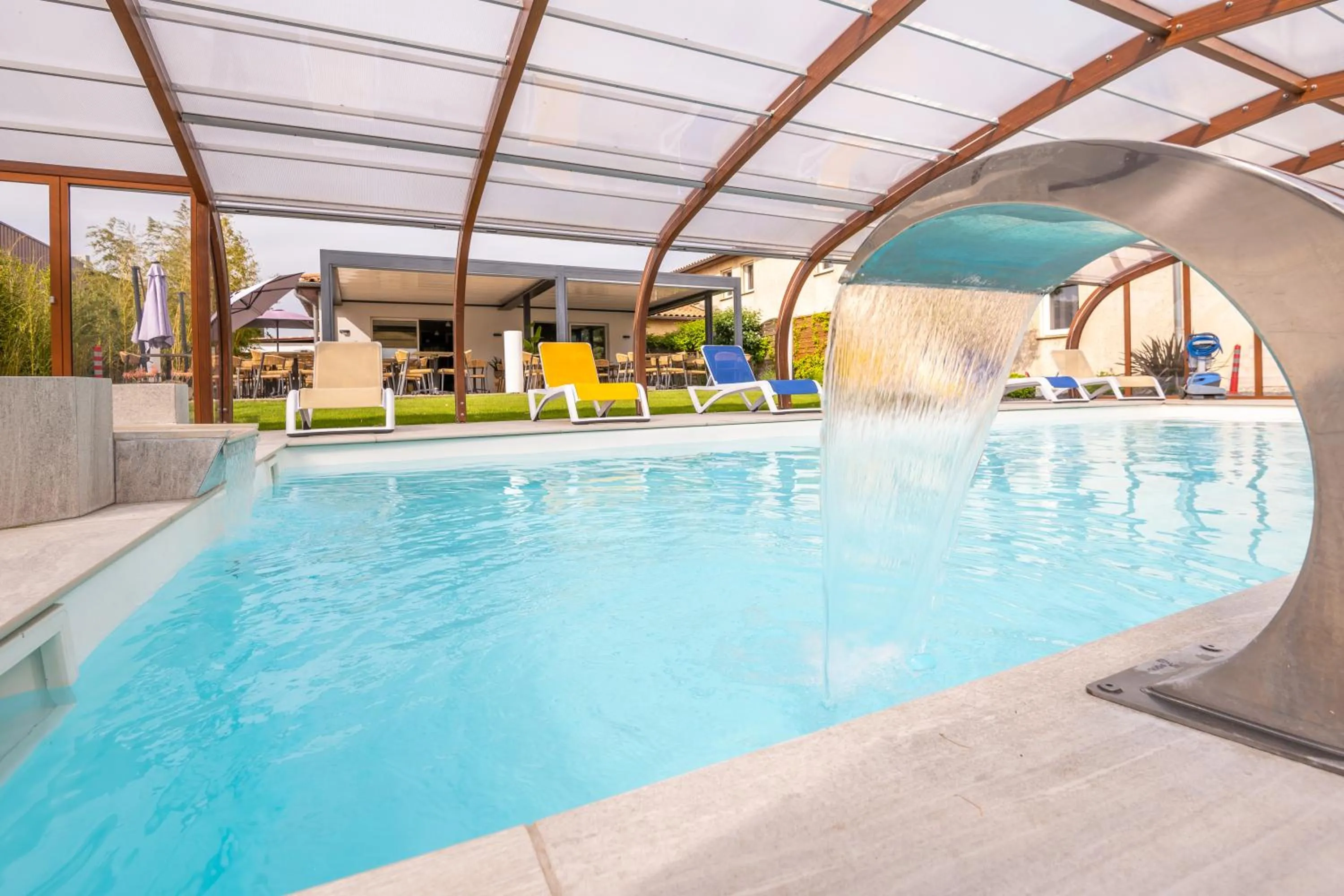 Swimming pool in LOGIS Hôtel Restaurant Le Clos Fleuri